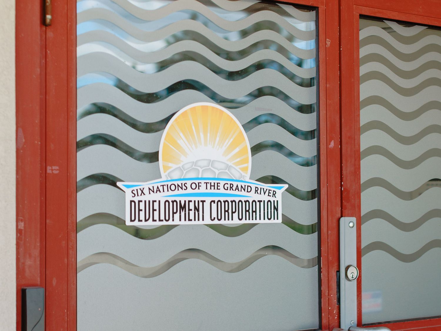 Six Nations of the Grand River Development Corporation logo on frosted glass door.
