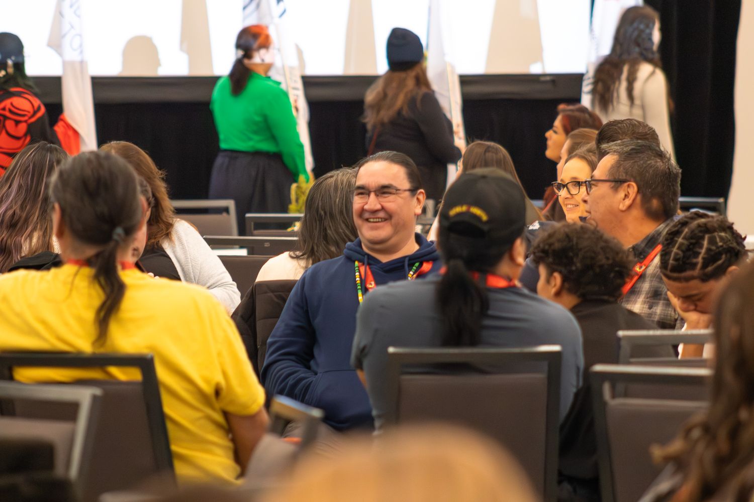 Conference attendees seated and engaging in discussion during an event.