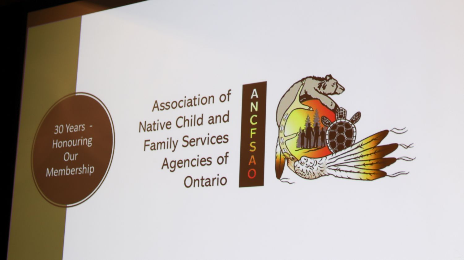Conference signage showing Association of Native Child and Family Services of Ontario with decorative elements.