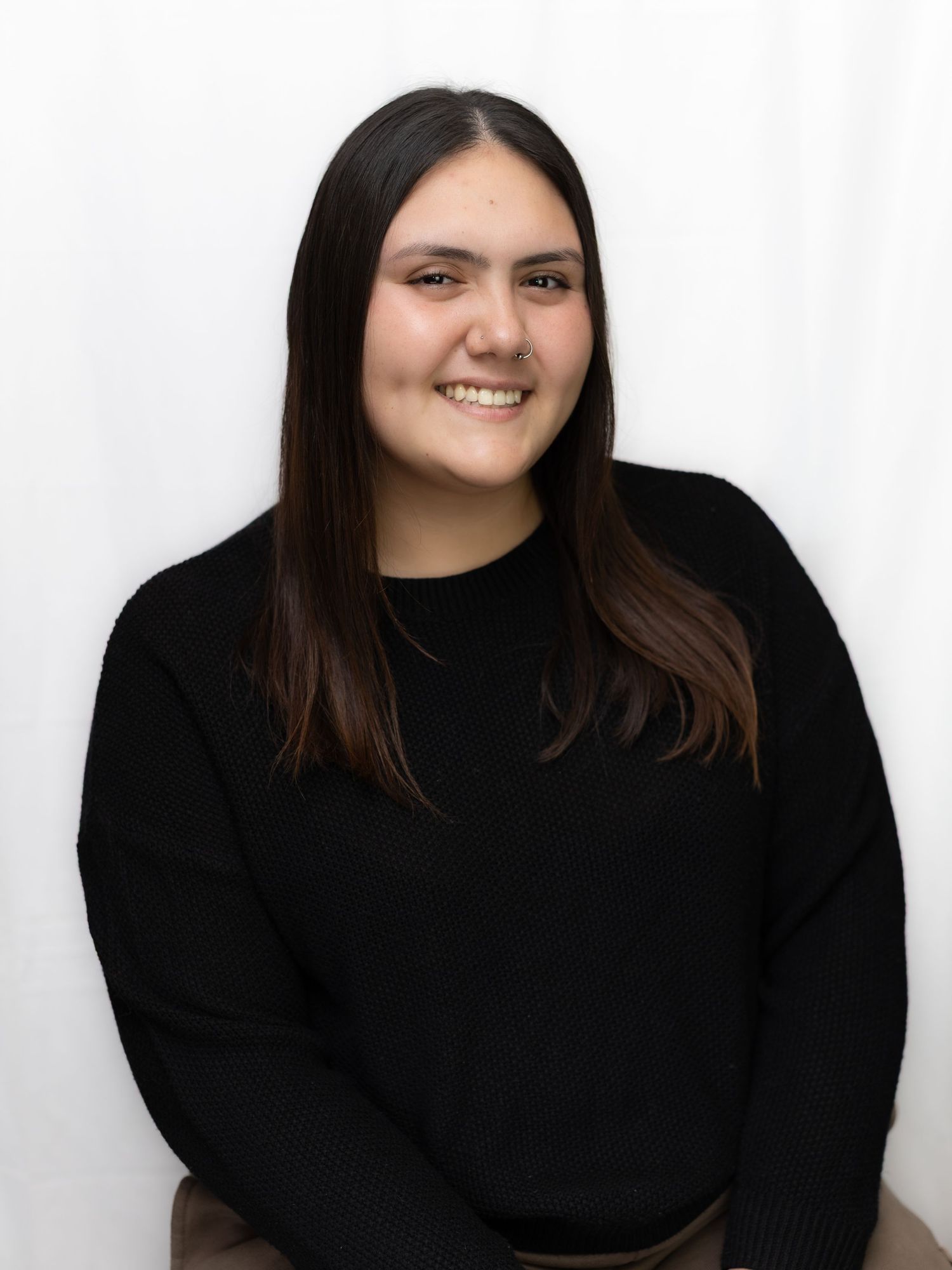 Multiple portrait poses of someone wearing a black turtleneck against a white background.