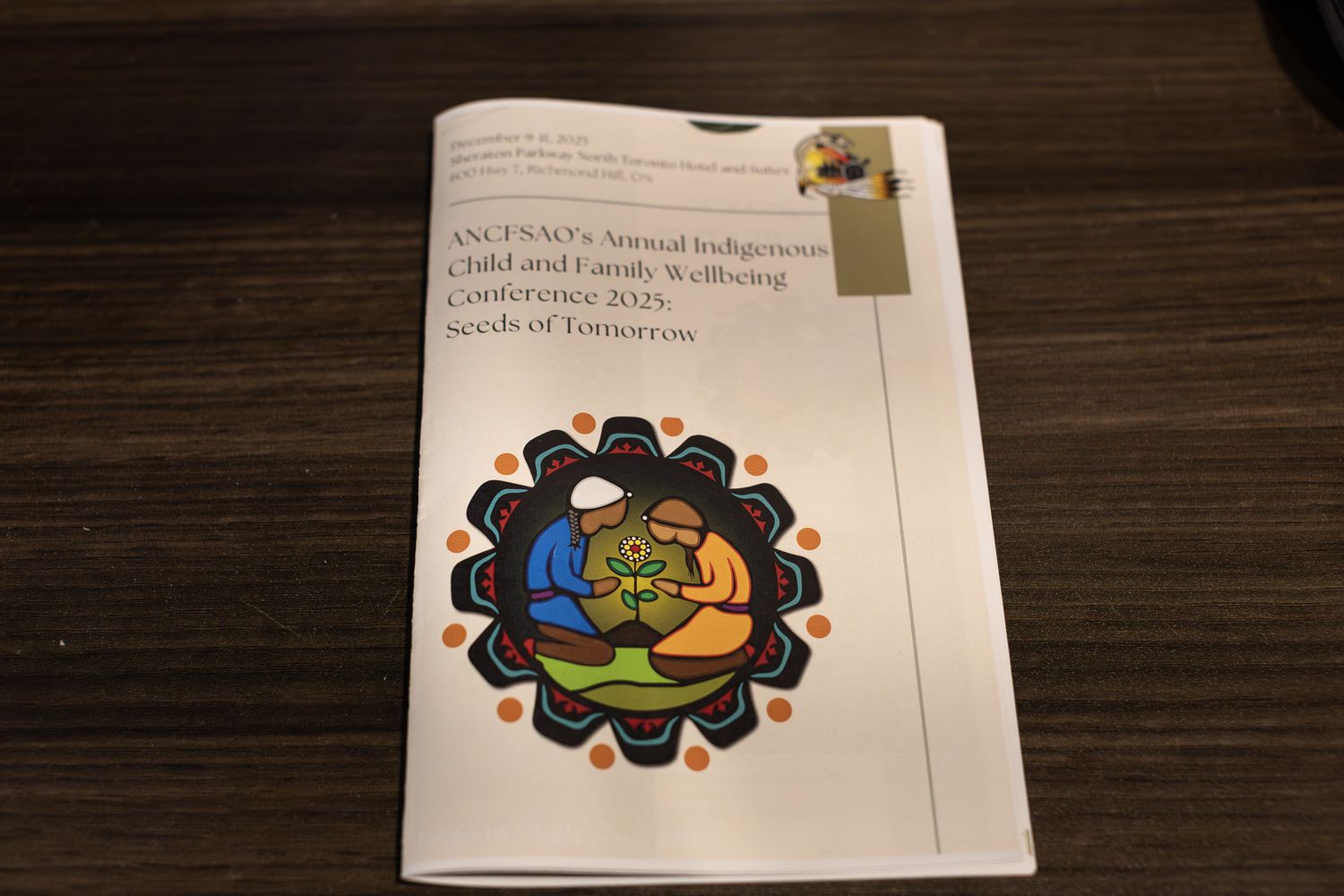 ANCFSAO Annual Indigenous Child and Family Wellbeing Conference 2023 Seeds of Tomorrow program booklet on a table.