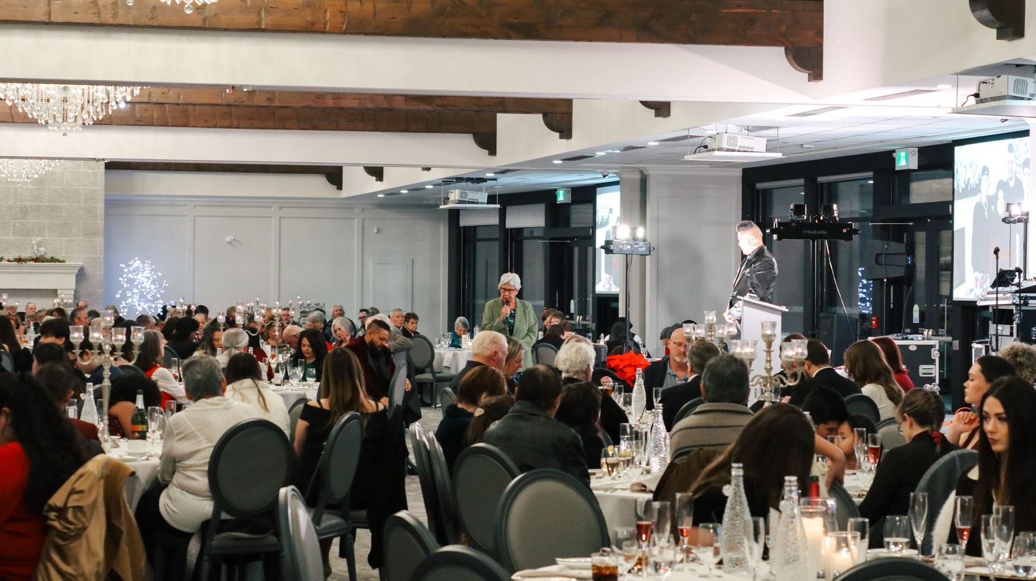 Wide view of a modern event space with tables and chairs arranged for a large gathering.