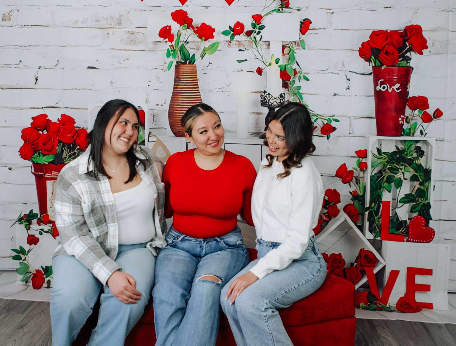 Family photo session with valentine decorations and red accents.