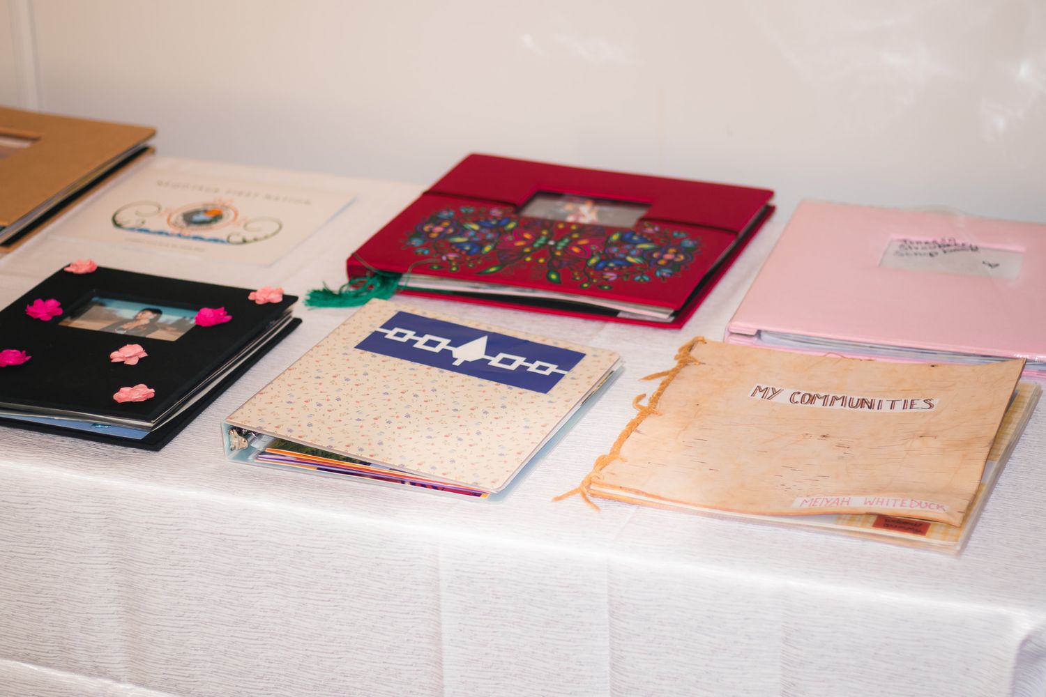 Collection of books and documents laid out on display table.