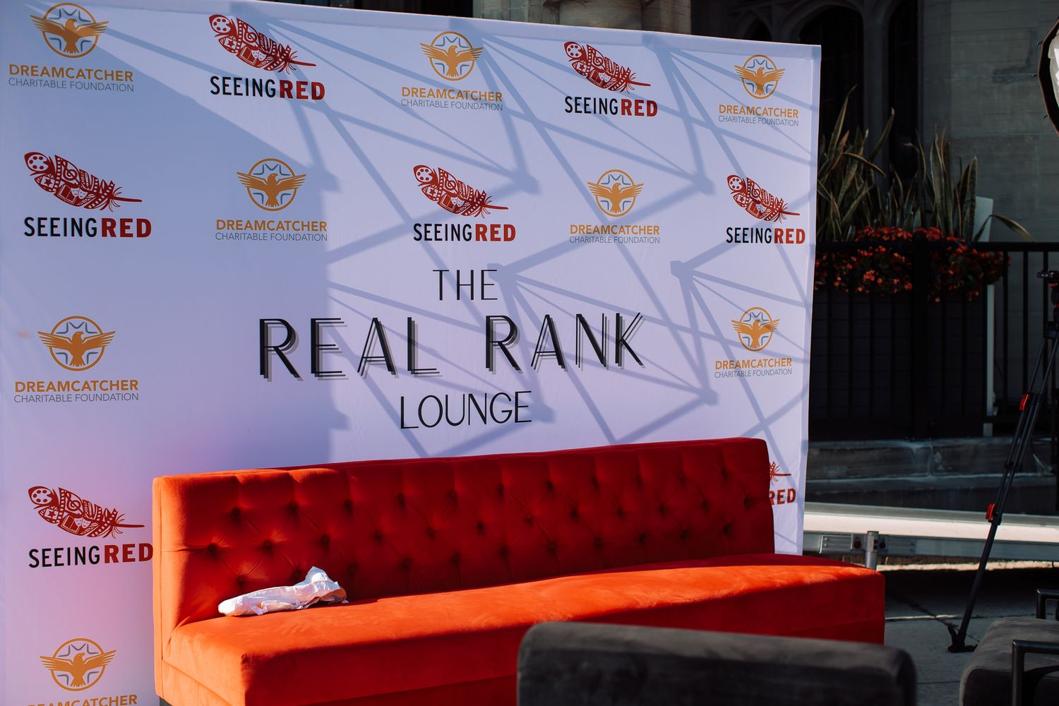 Event space with branded backdrop displaying 'Real Rank' and 'Lounge' signage.