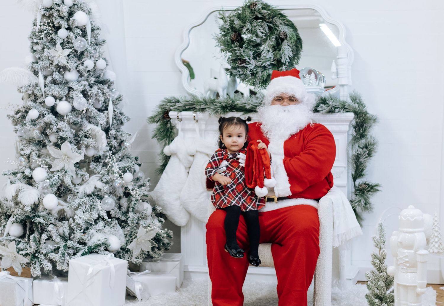 Holiday portrait setup with decorated Christmas tree and white fireplace mantel.