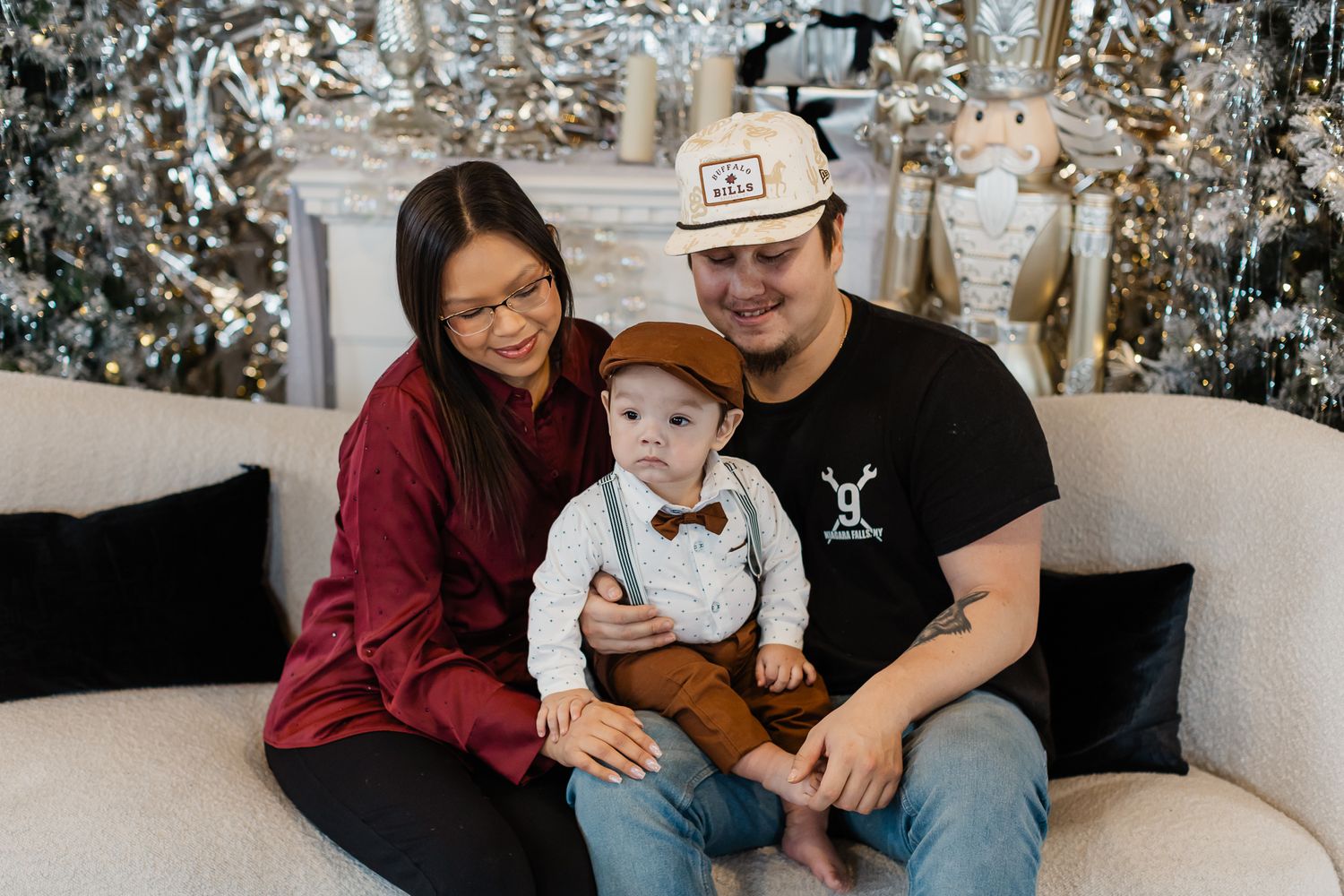 Family portrait with holiday decor featuring matching outfits and coordinated styling.