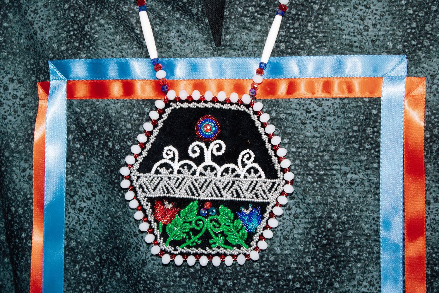 Decorative beaded crowns and designs displayed on dark background with colorful lighting effects.