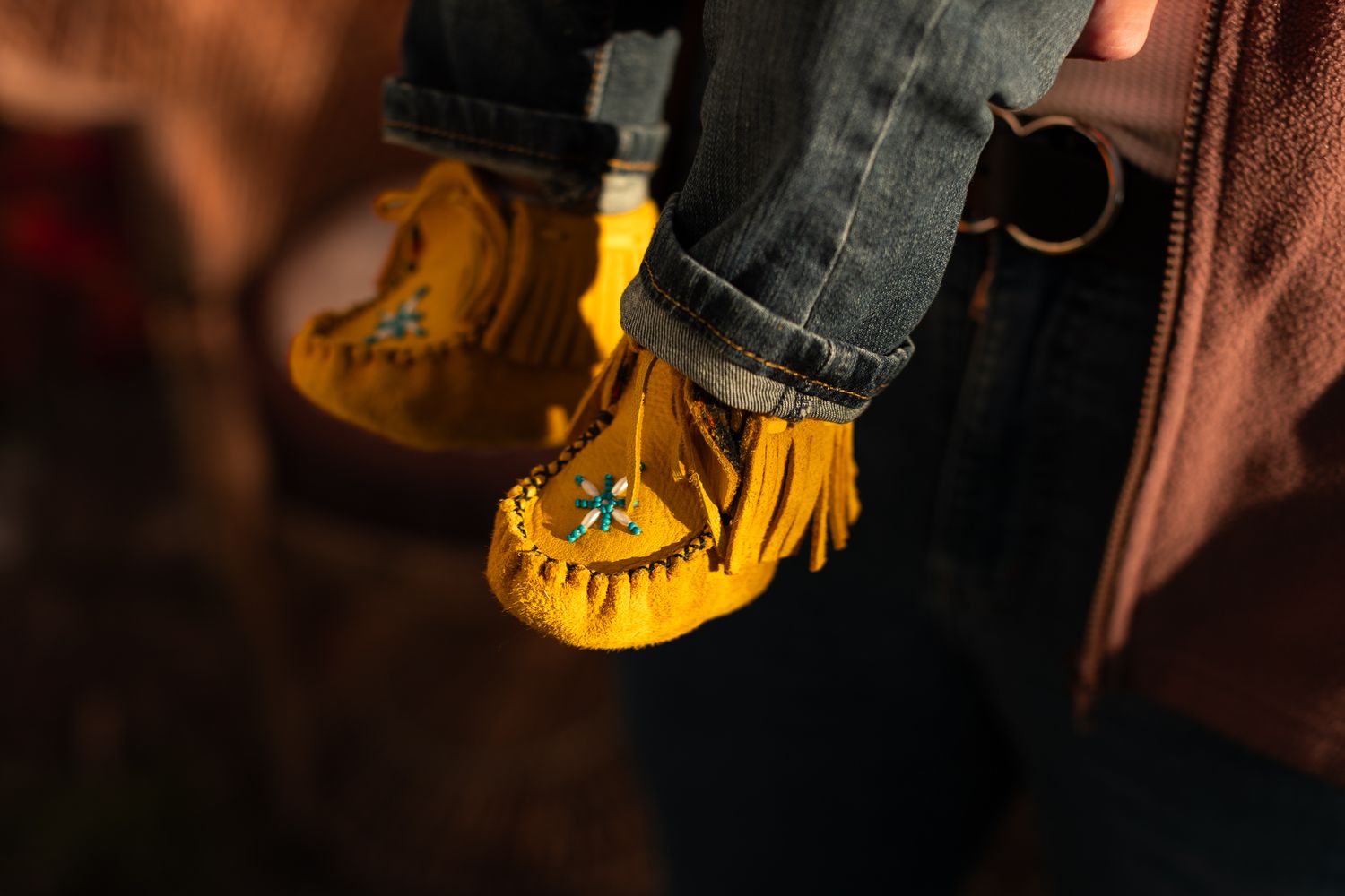 Close-up detail shot of yellow and gold autumn accessories in dim lighting.