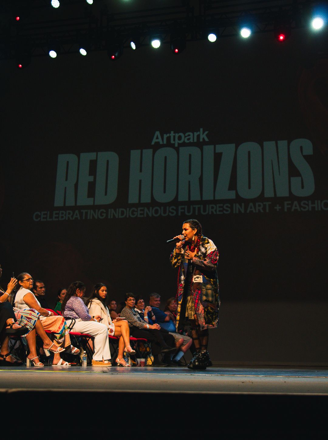 Dance performance on stage with dramatic lighting and 'Red Horizons' text display.