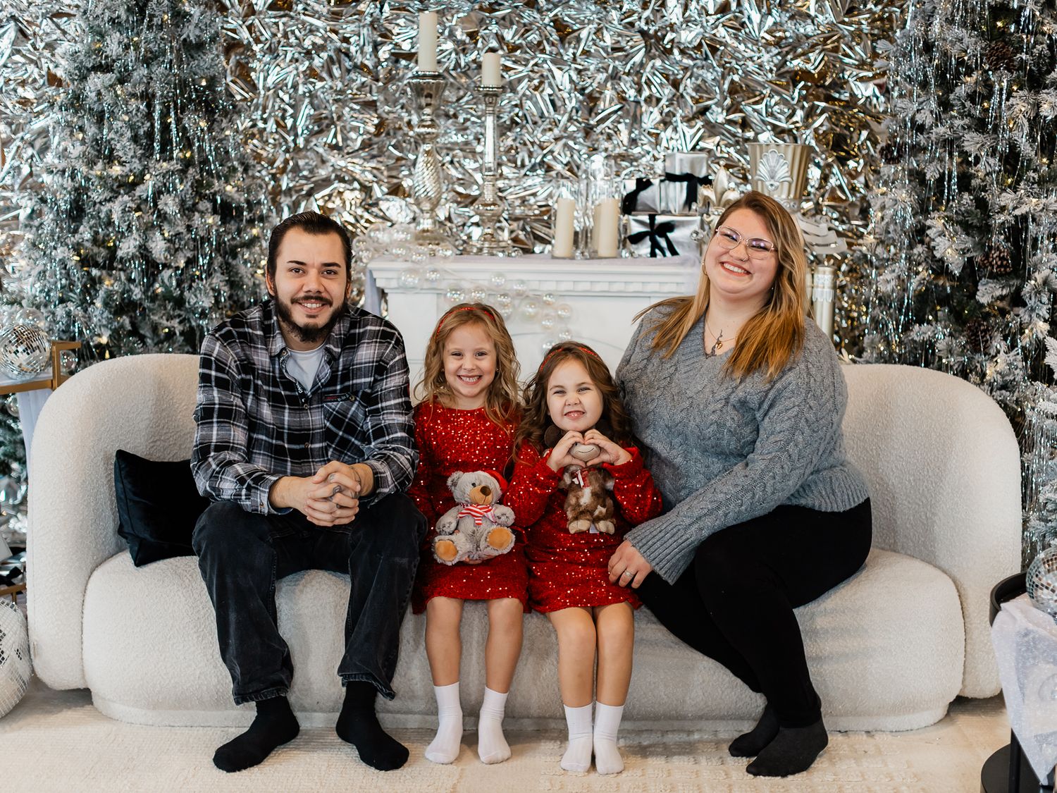 Relaxed family portrait session with festive winter decor and Christmas tree.