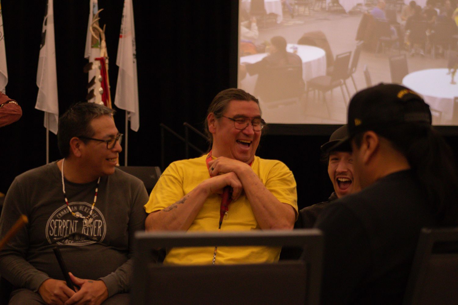 Audience members react during what appears to be an entertaining presentation.