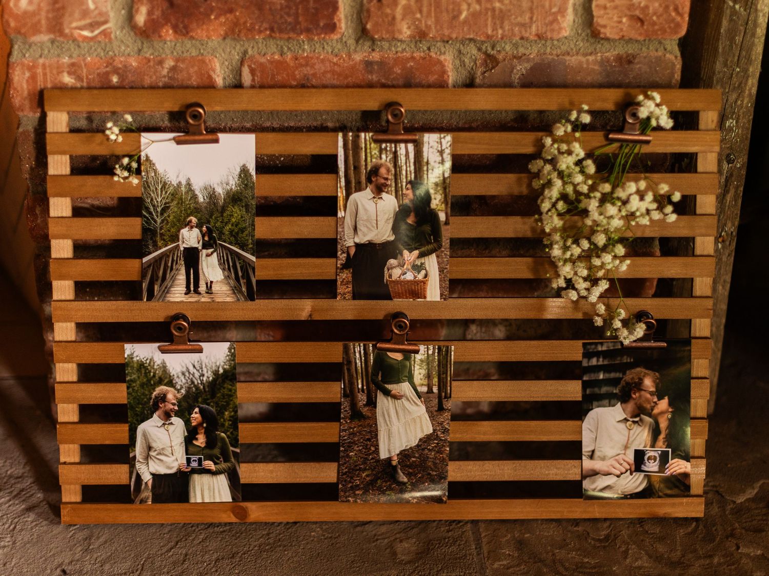 Wooden pallet wall display decorated with floral arrangements and string lights for wedding decor.