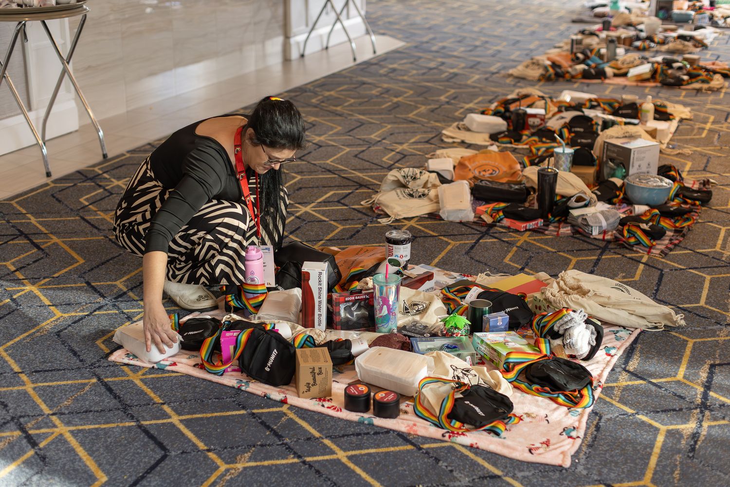 Various items and materials spread across carpeted floor during an indoor activity.