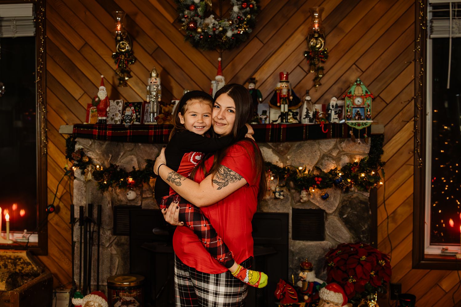 Festive indoor setting with Christmas tree, diagonal wood paneling, and holiday decor.