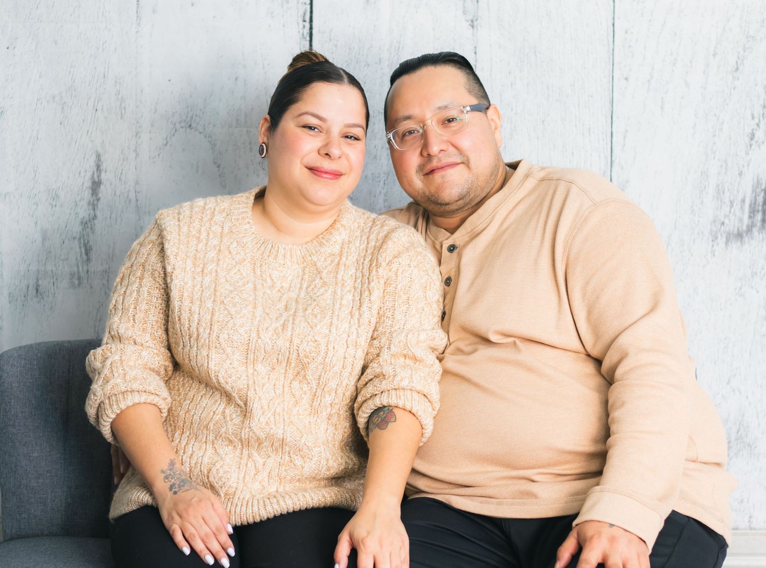 Series of romantic couple portraits against white wooden wall showing natural affection.