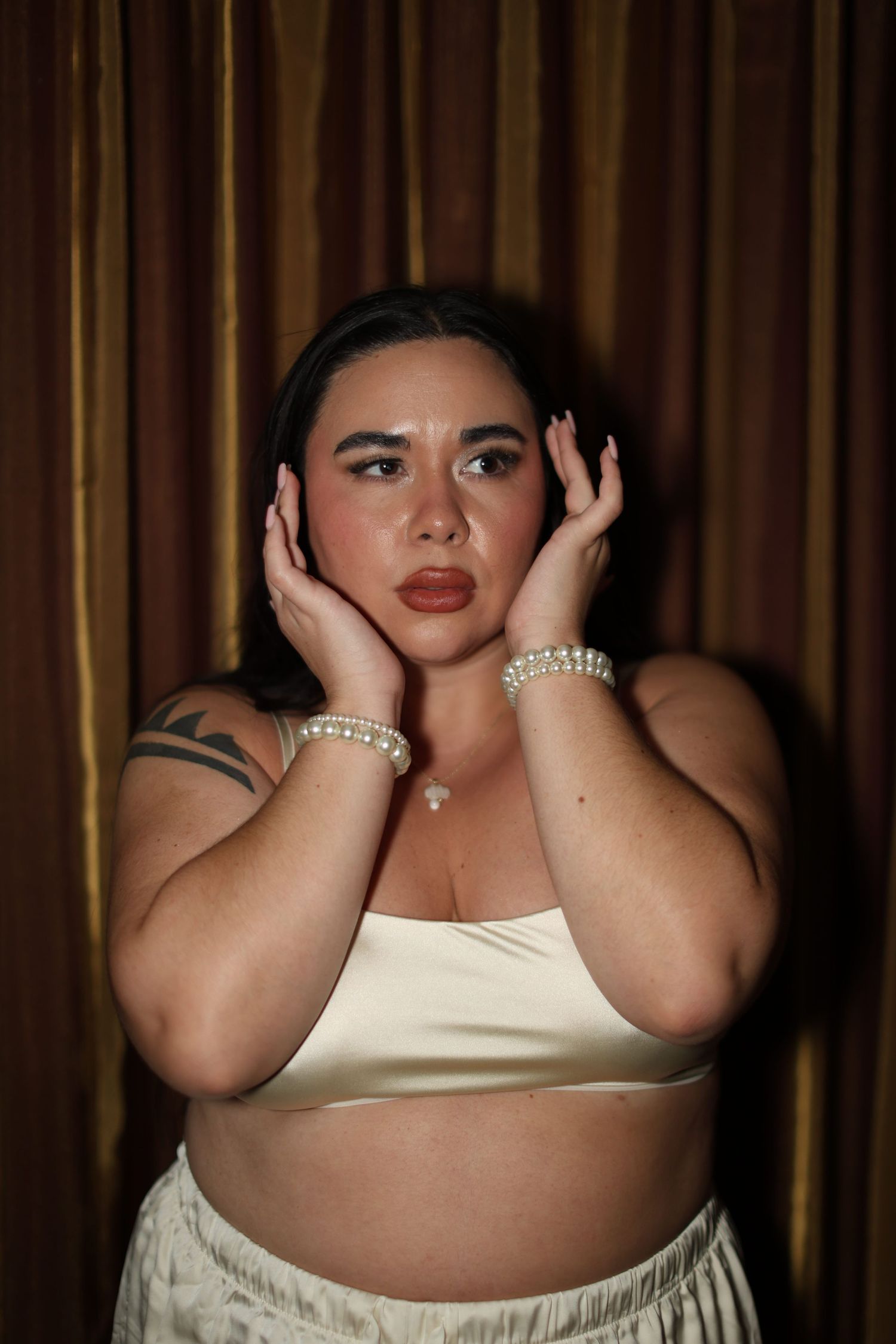 Portrait session against brown curtain backdrop showing dramatic poses.