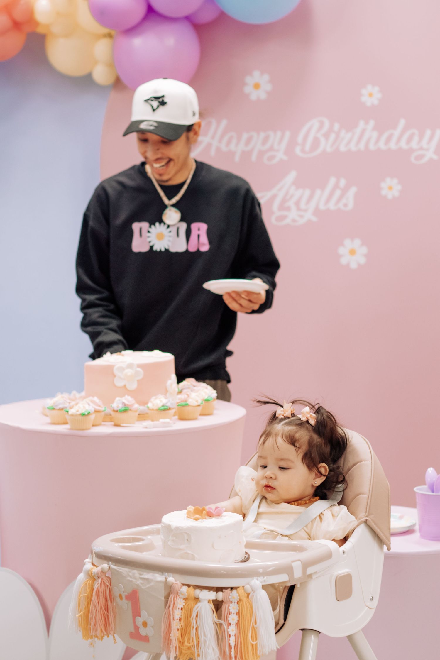 Birthday party scene with colorful balloons and decorations in pink tones.