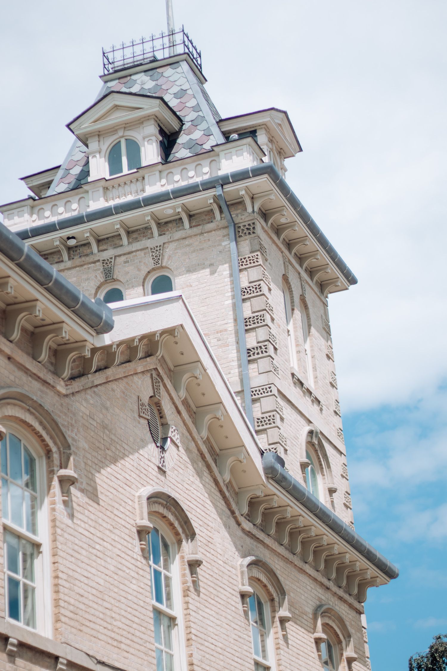 Historic white stone building facade with ornate architectural details and windows.