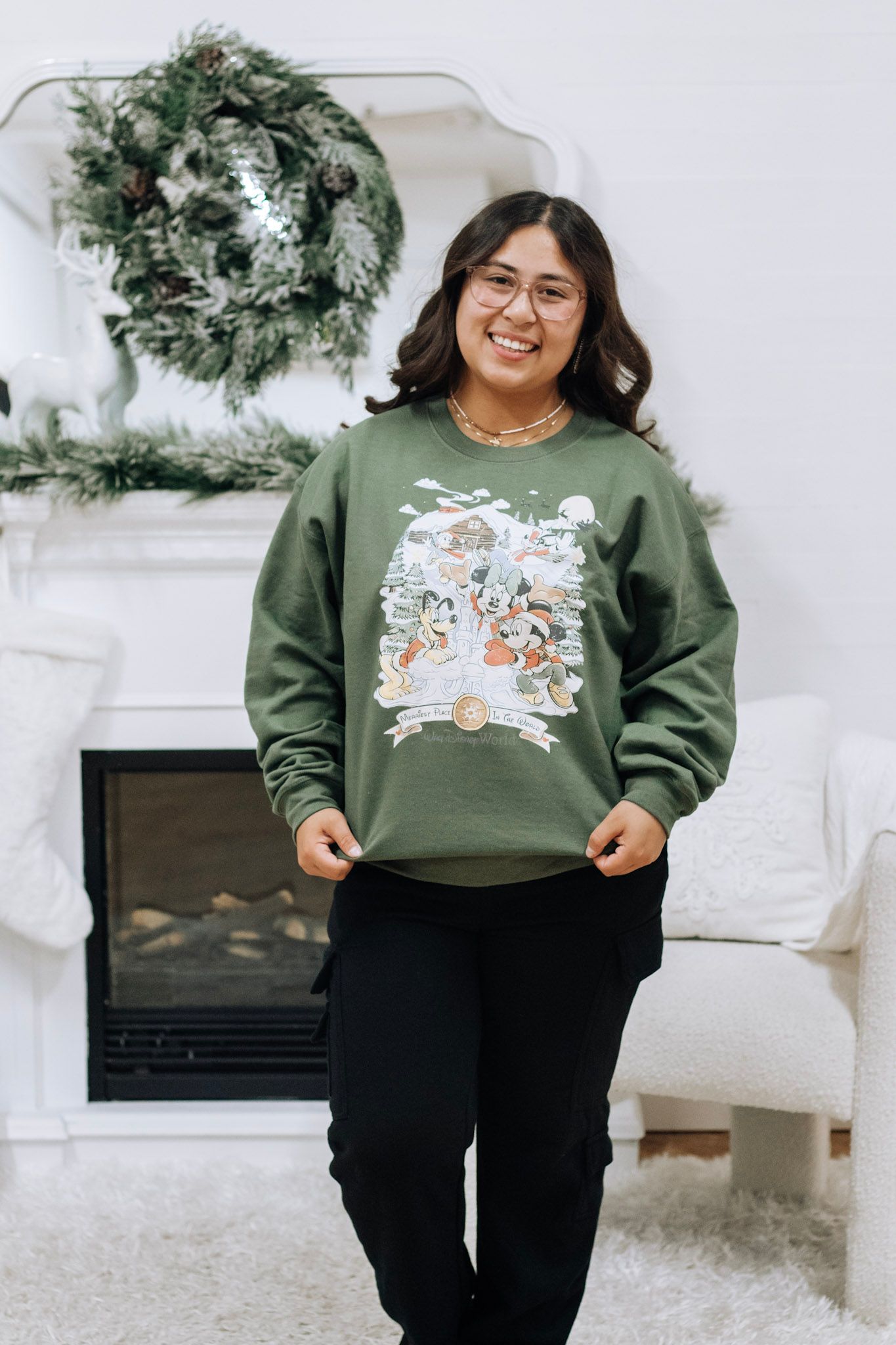 Holiday themed sweatshirt photoshoot with festive winter decorations and white Christmas trees.