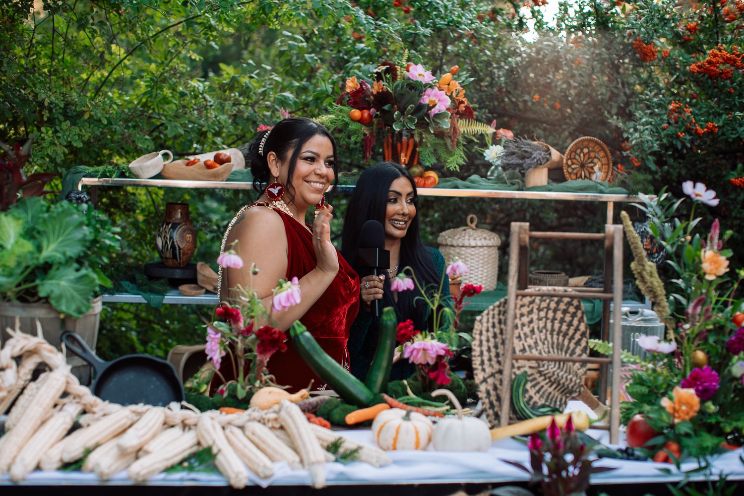 Outdoor garden party setup with floral decorations and table settings in natural lighting.