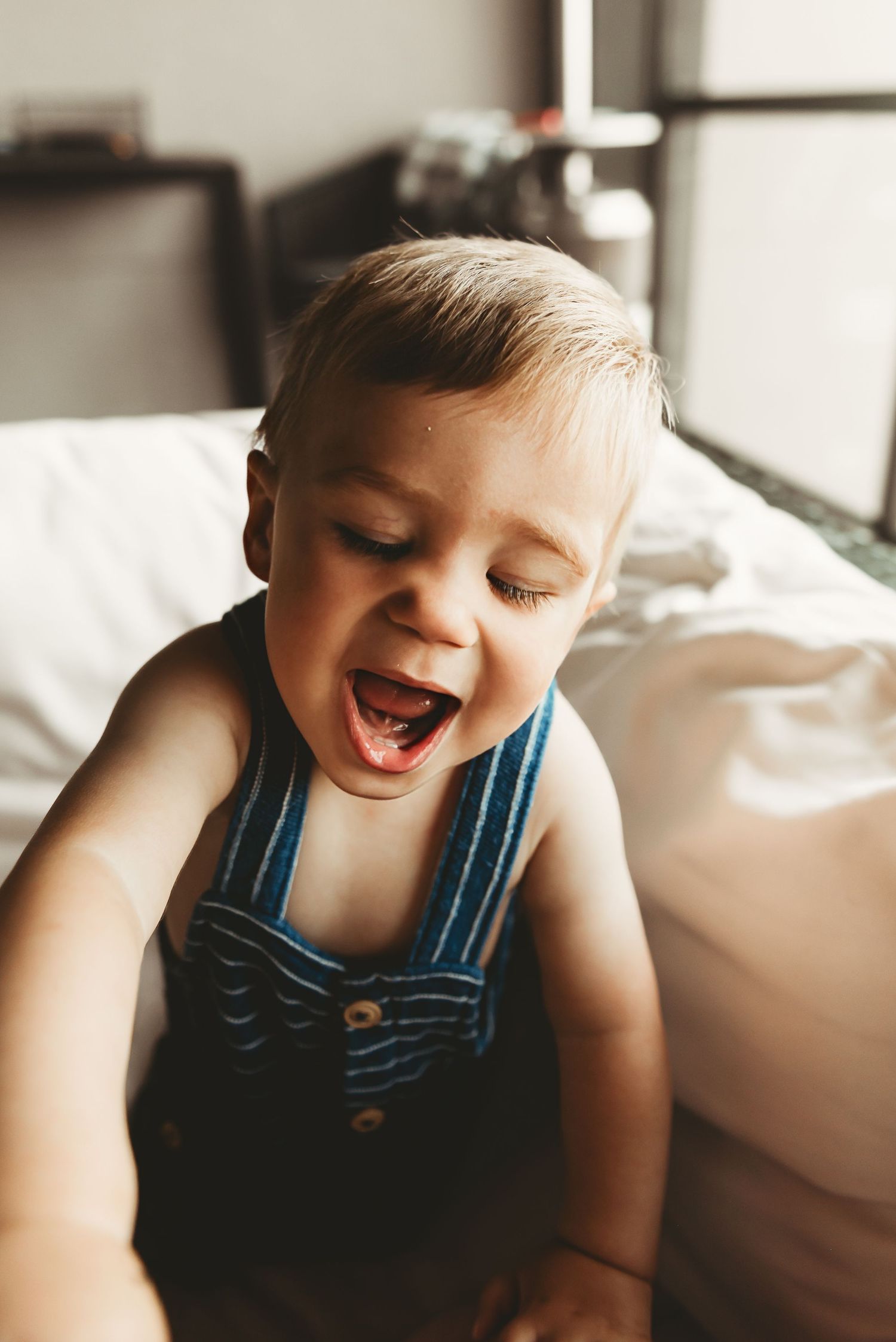A candid series of joyful expressions in natural window light.