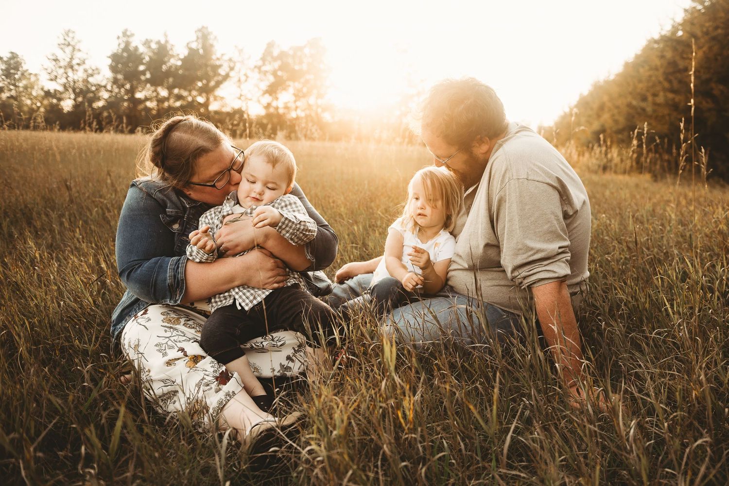 A family has a simple yet delightful moment hanging out in a meadow at sunset at Sweet Briar Lake. Nothing quite like a golden sunset