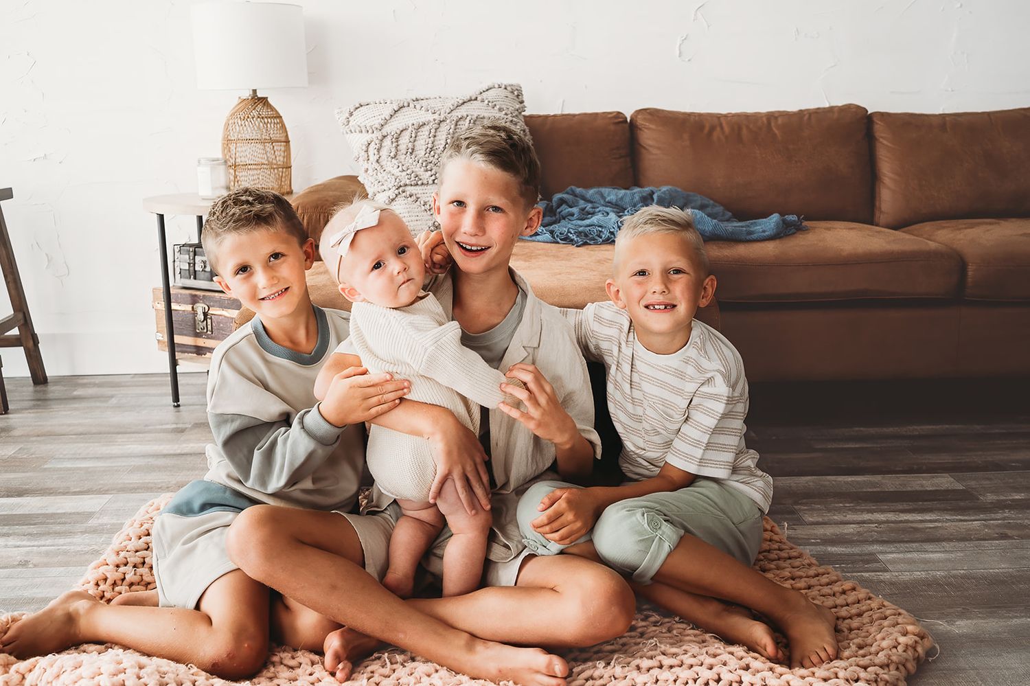 Family lifestyle scene on a cozy living room floor with natural candid moments.