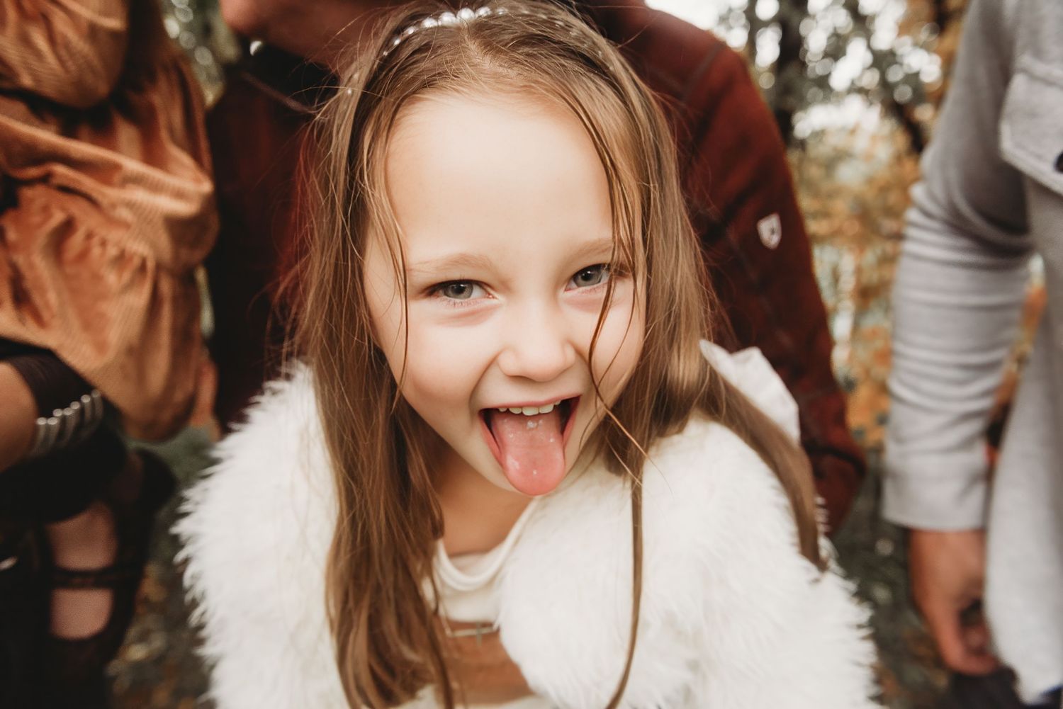 Playful expressions and silly faces captured in warm autumn light.
