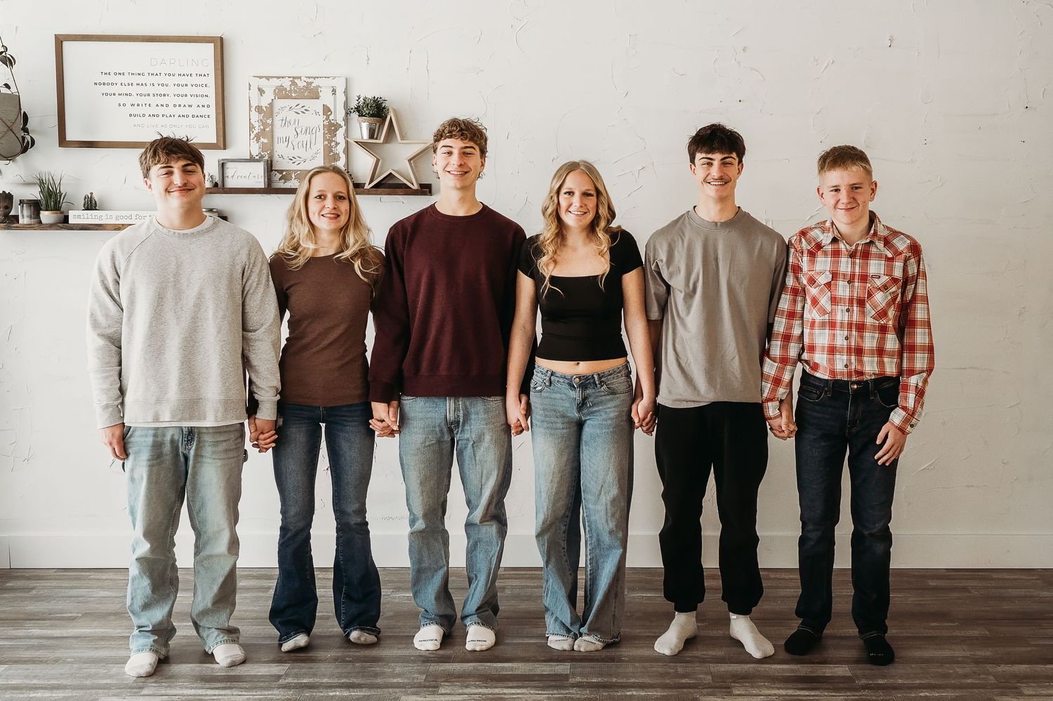 In a lineup from oldest to youngest, this group of cousins create a cute and fun memory together for Grandma during a family get together