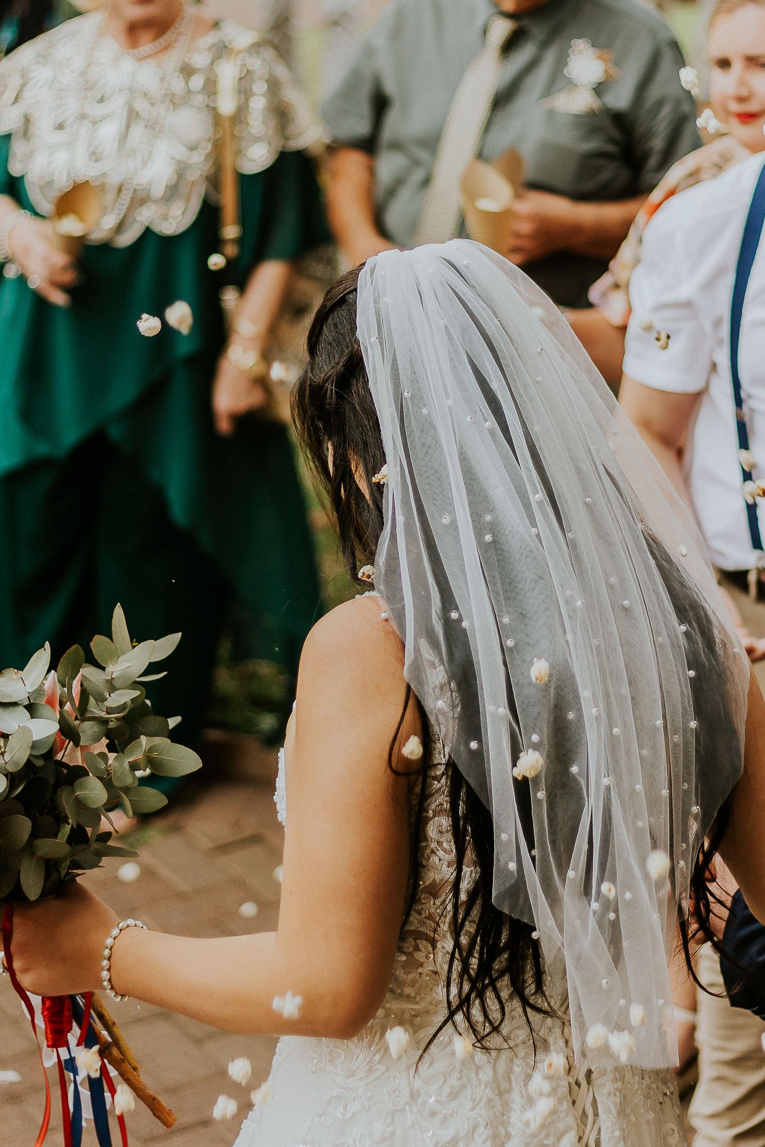 Joyful candid shot of a bride walking into her wedding reception venue.