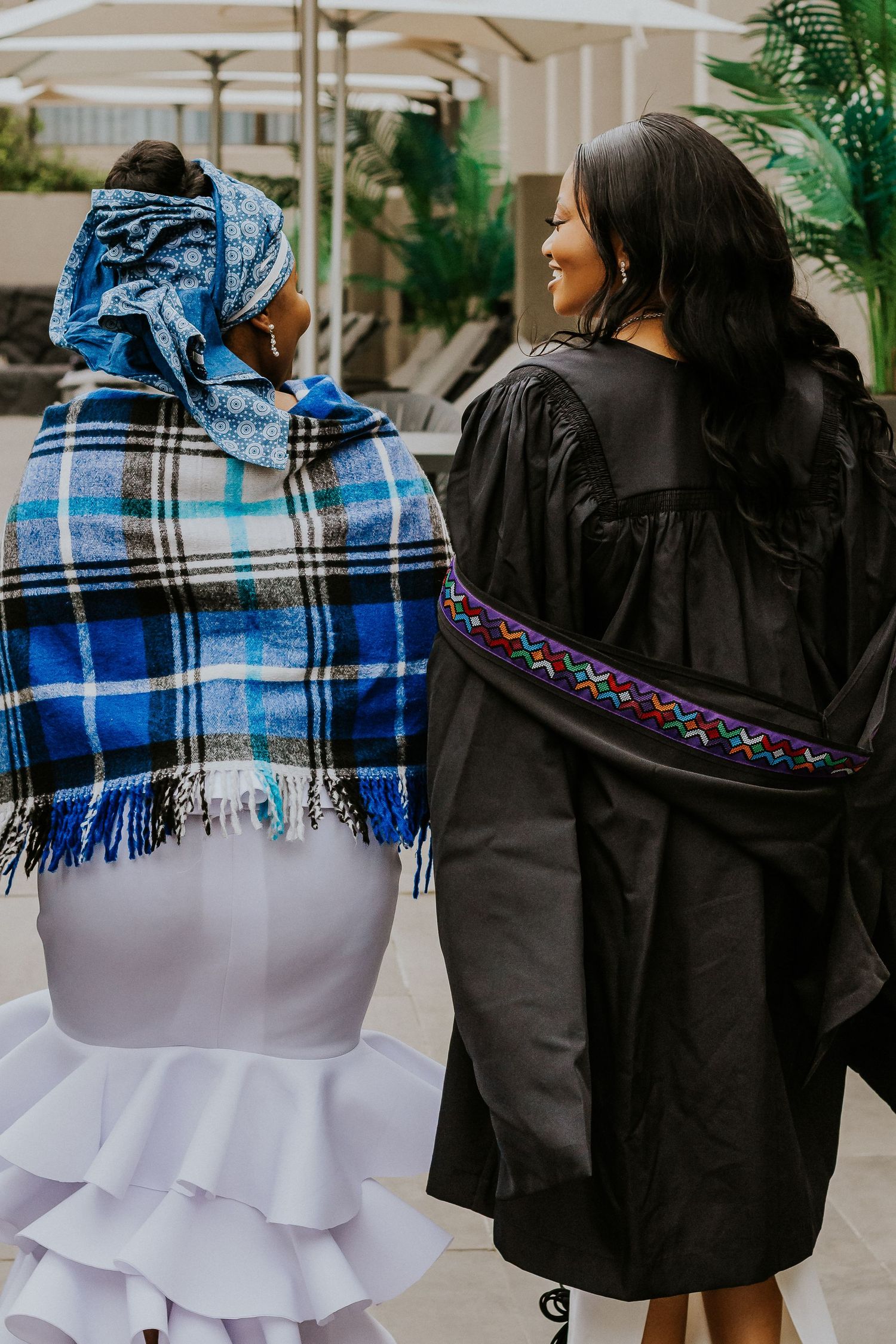 Professional graduation portrait of a proud graduate in cap and gown, captured in natural light, celebrating academic success.