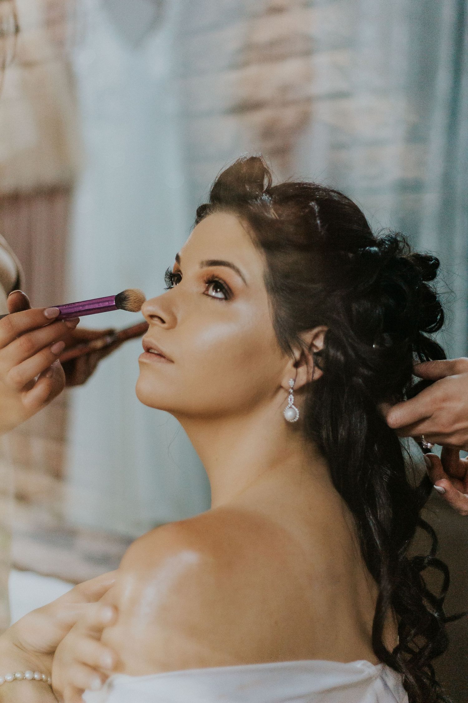 Stunning bridal portrait capturing the bride looking over her shoulder during wedding preparation.
