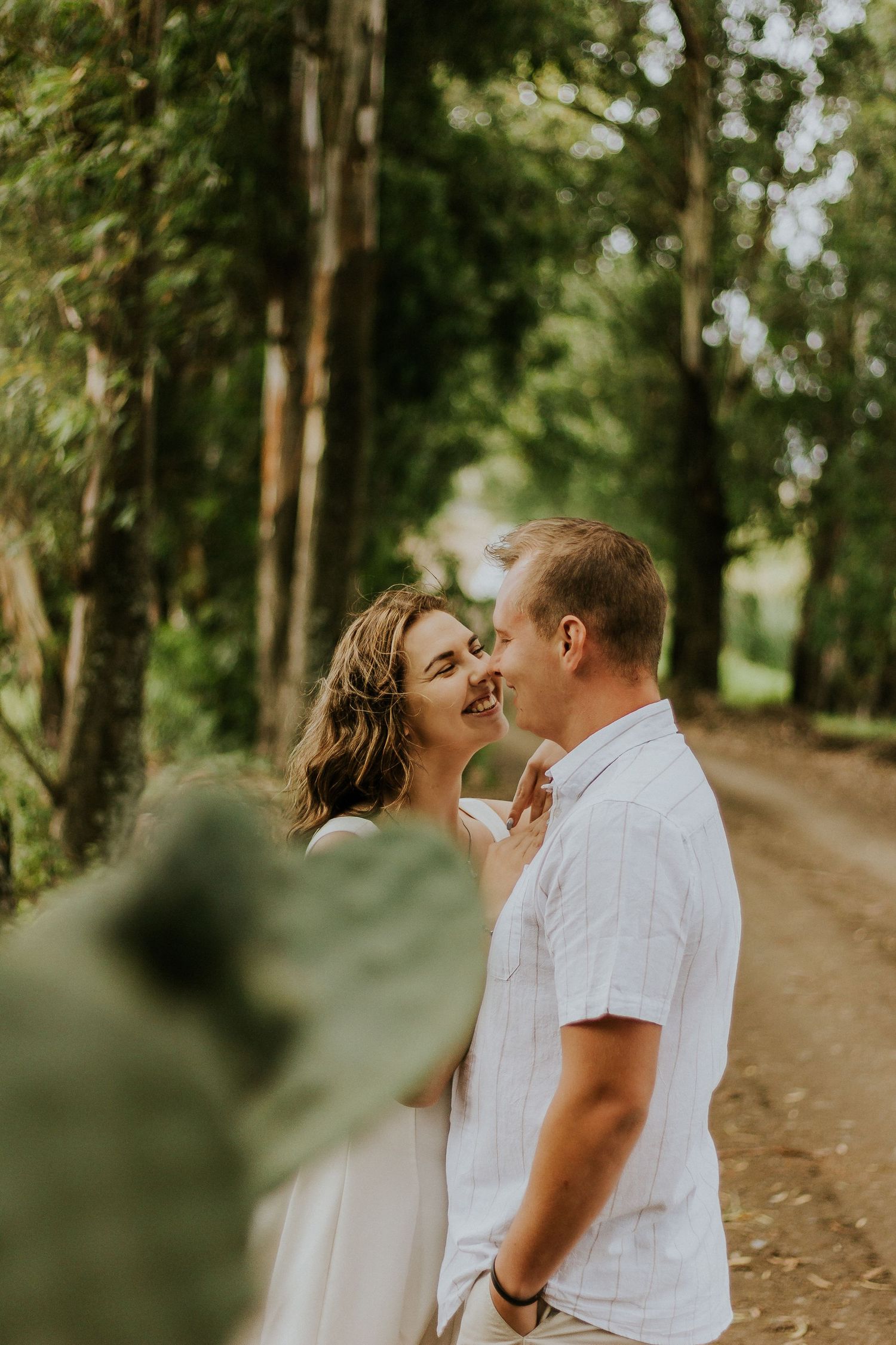 Romantic couple portrait in a forest pathway by Mr Portrait Photography