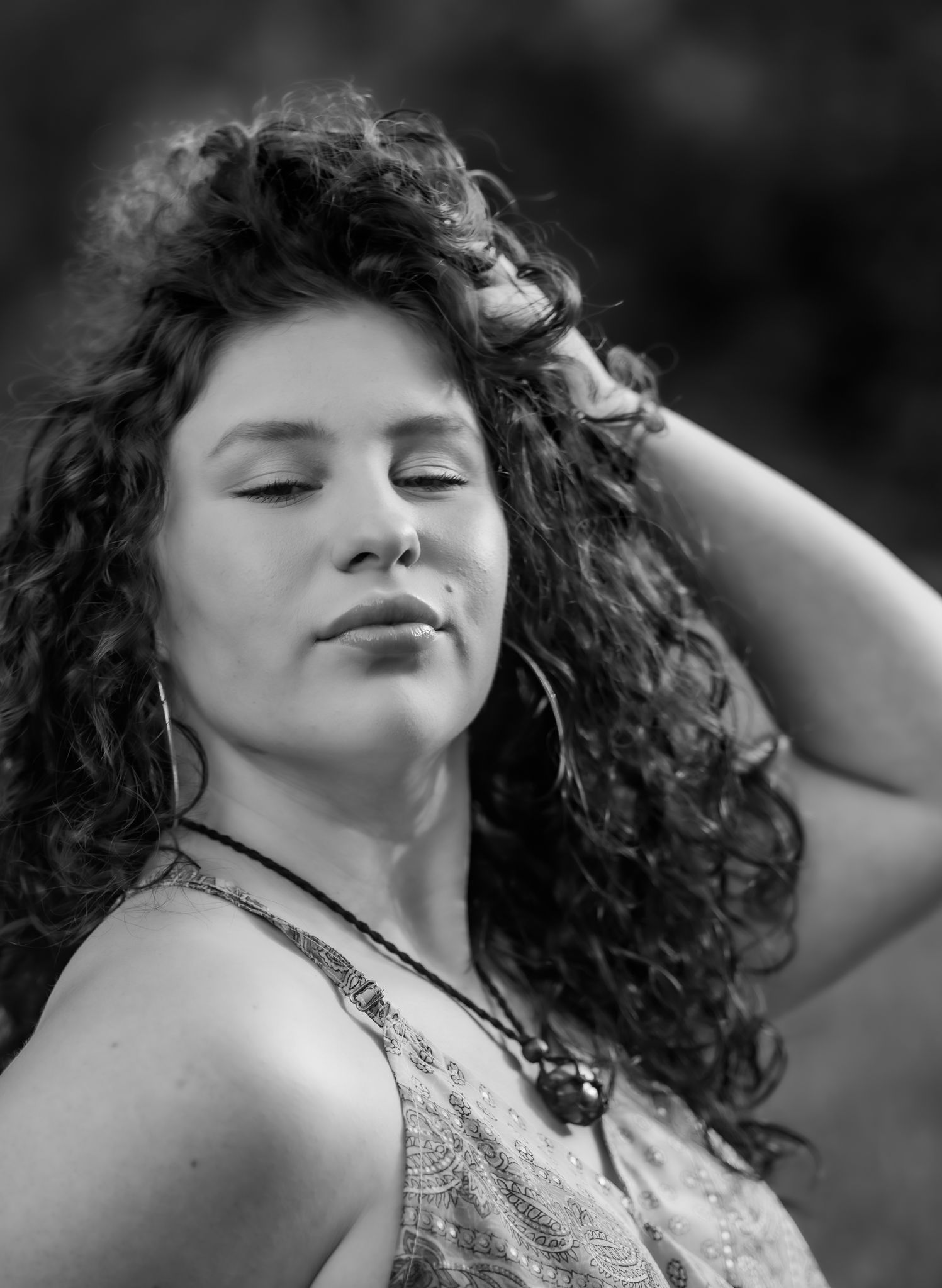Black and white close-up portraits showing dramatic expressions and curly hair.
