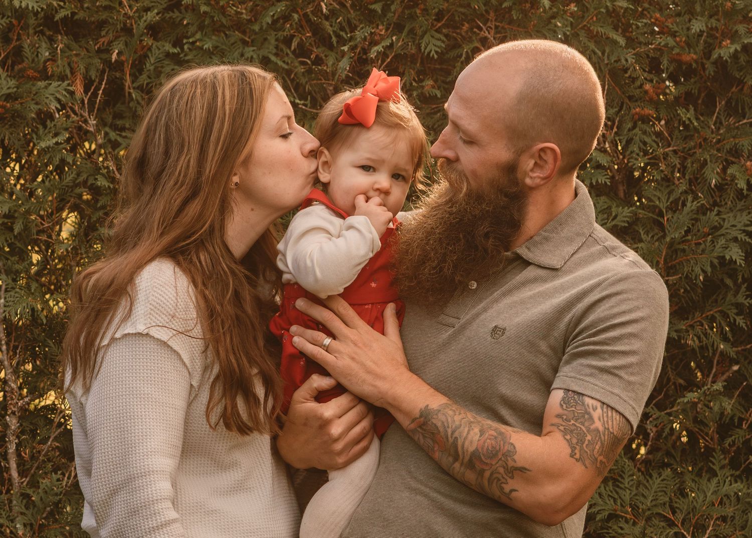 A sweet family moment captured outdoors during golden hour.