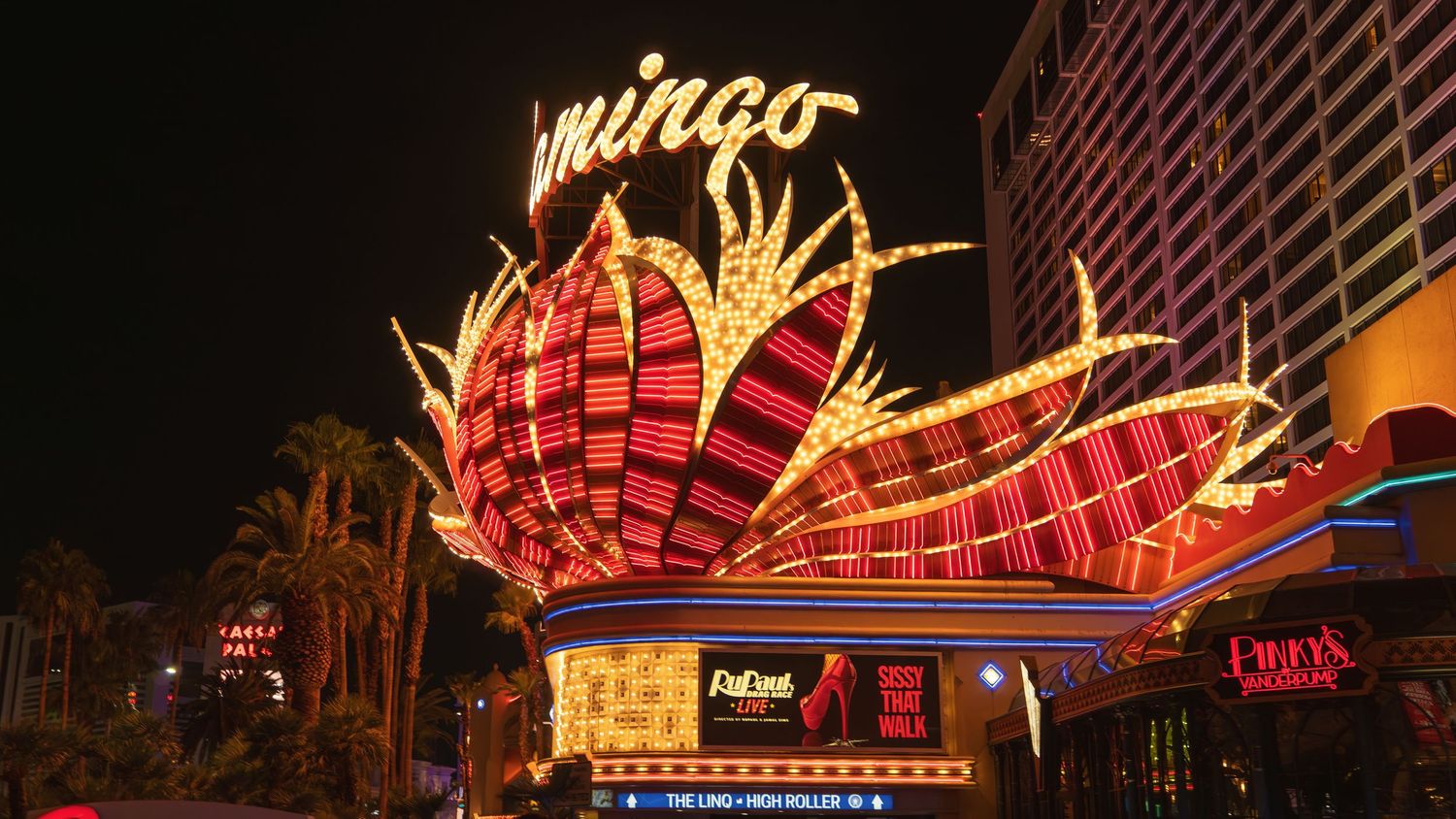 Illuminated Flamingo Casino sign glowing bright red against the Las Vegas night sky.