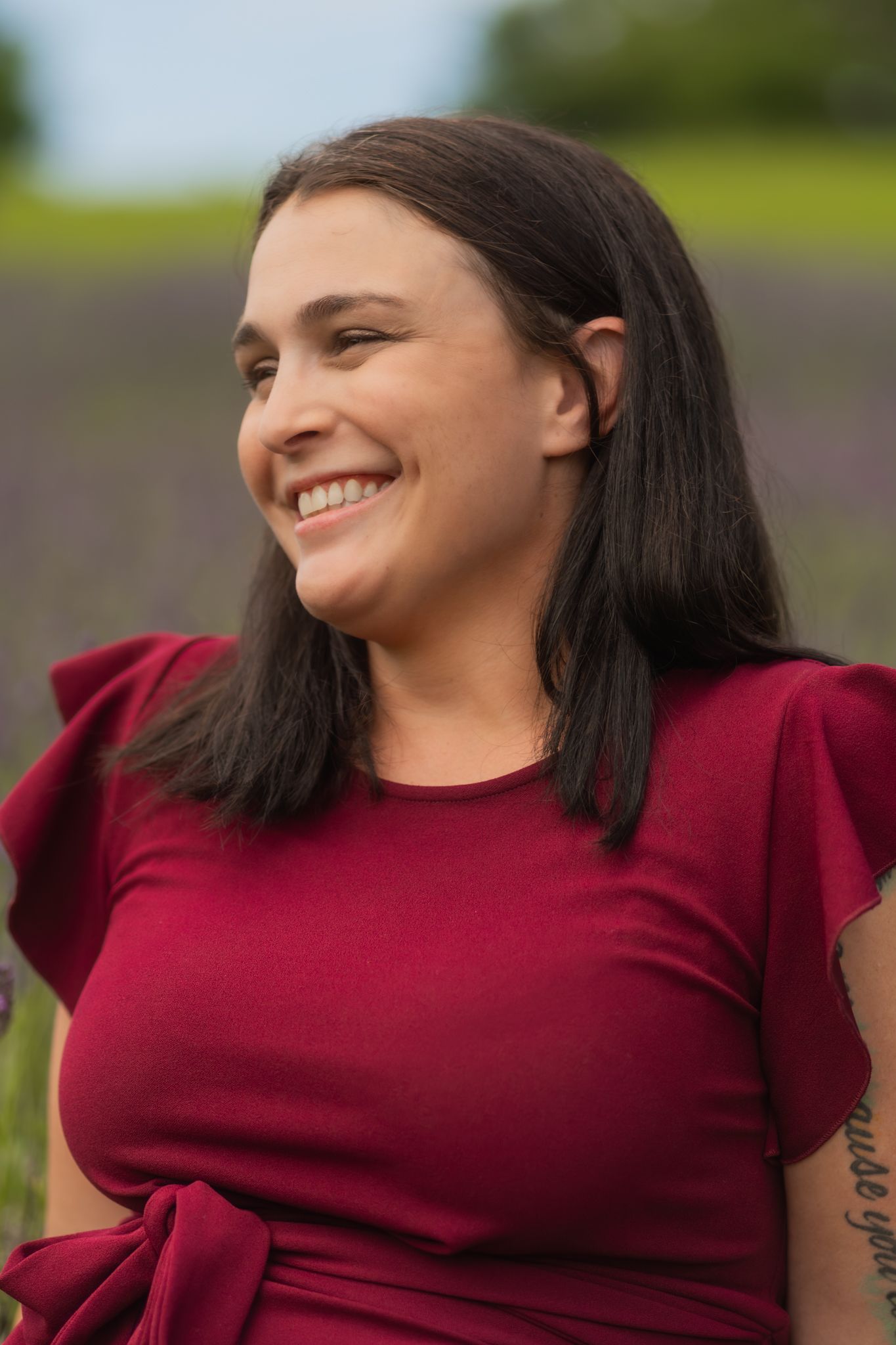 Candid portrait series in a lavender field showing joyful expressions.