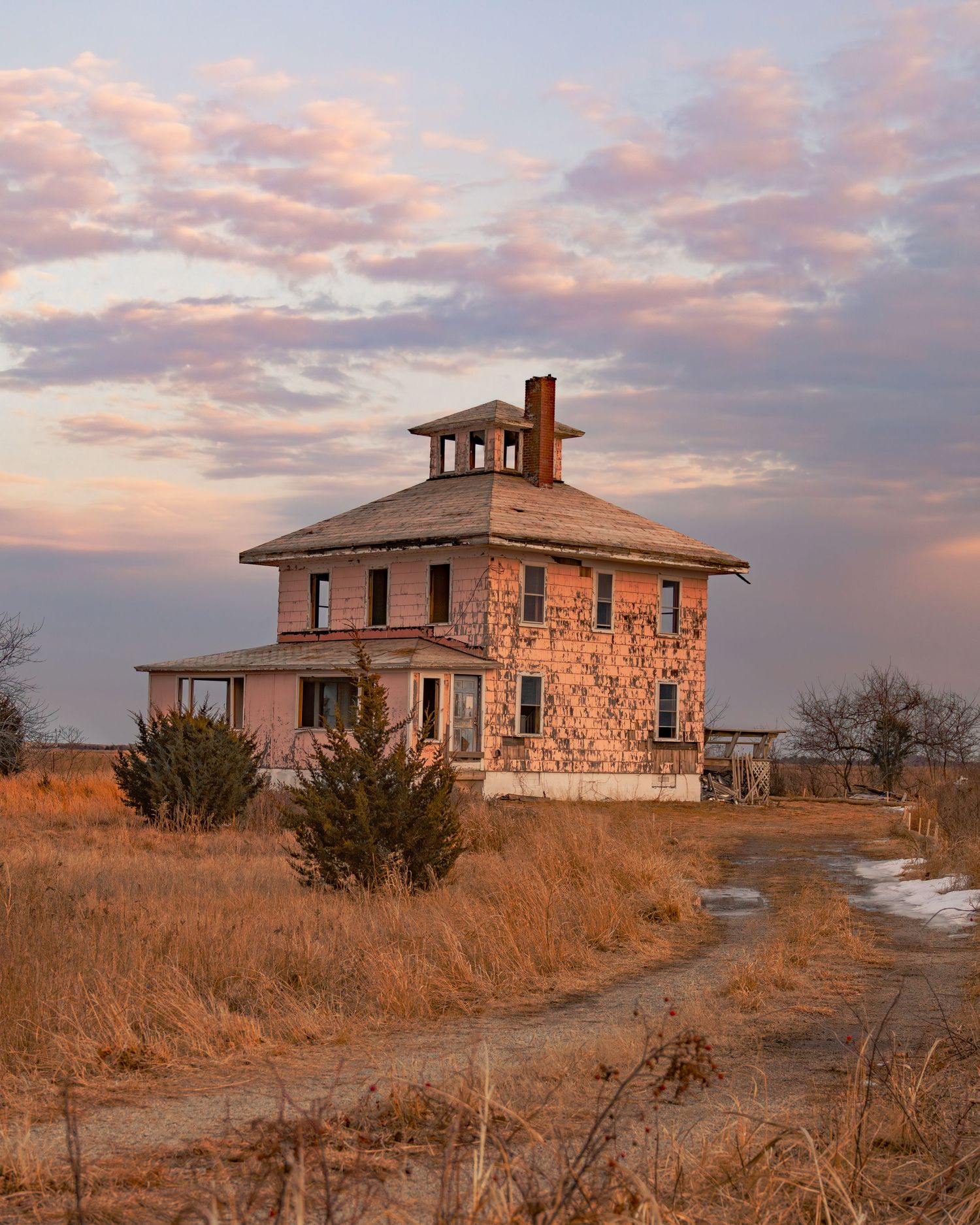 Abandoned Pink House on the wetlands during a colorful sunset.