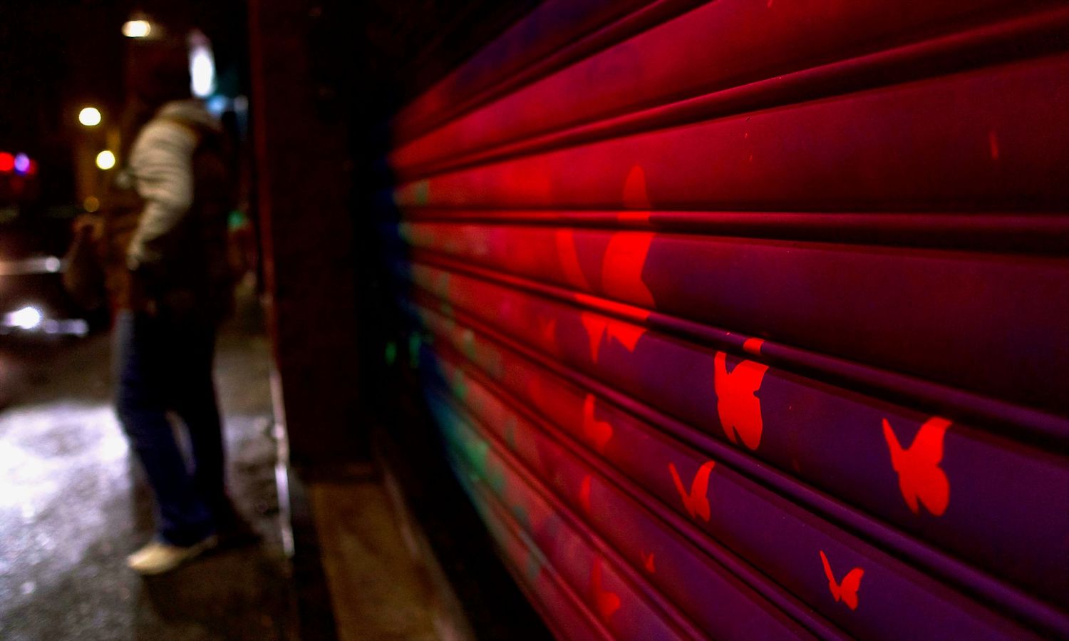 Artistic lighting installation with red neon lights creating geometric patterns.