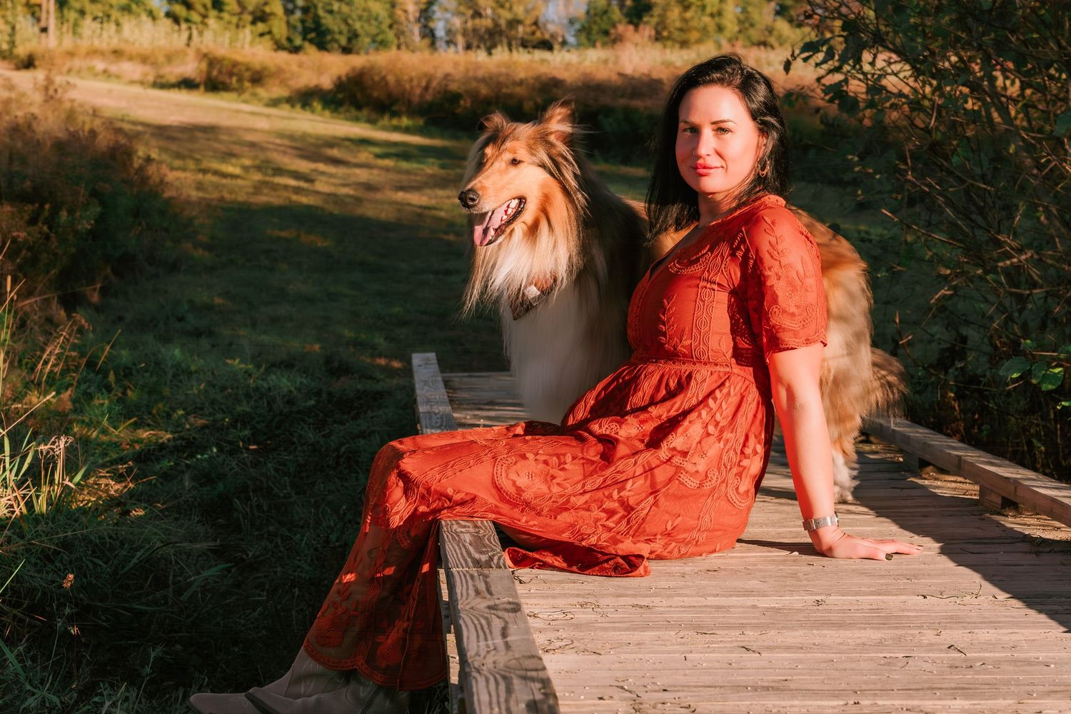 Outdoor photography session on a wooden platform with warm evening lighting.
