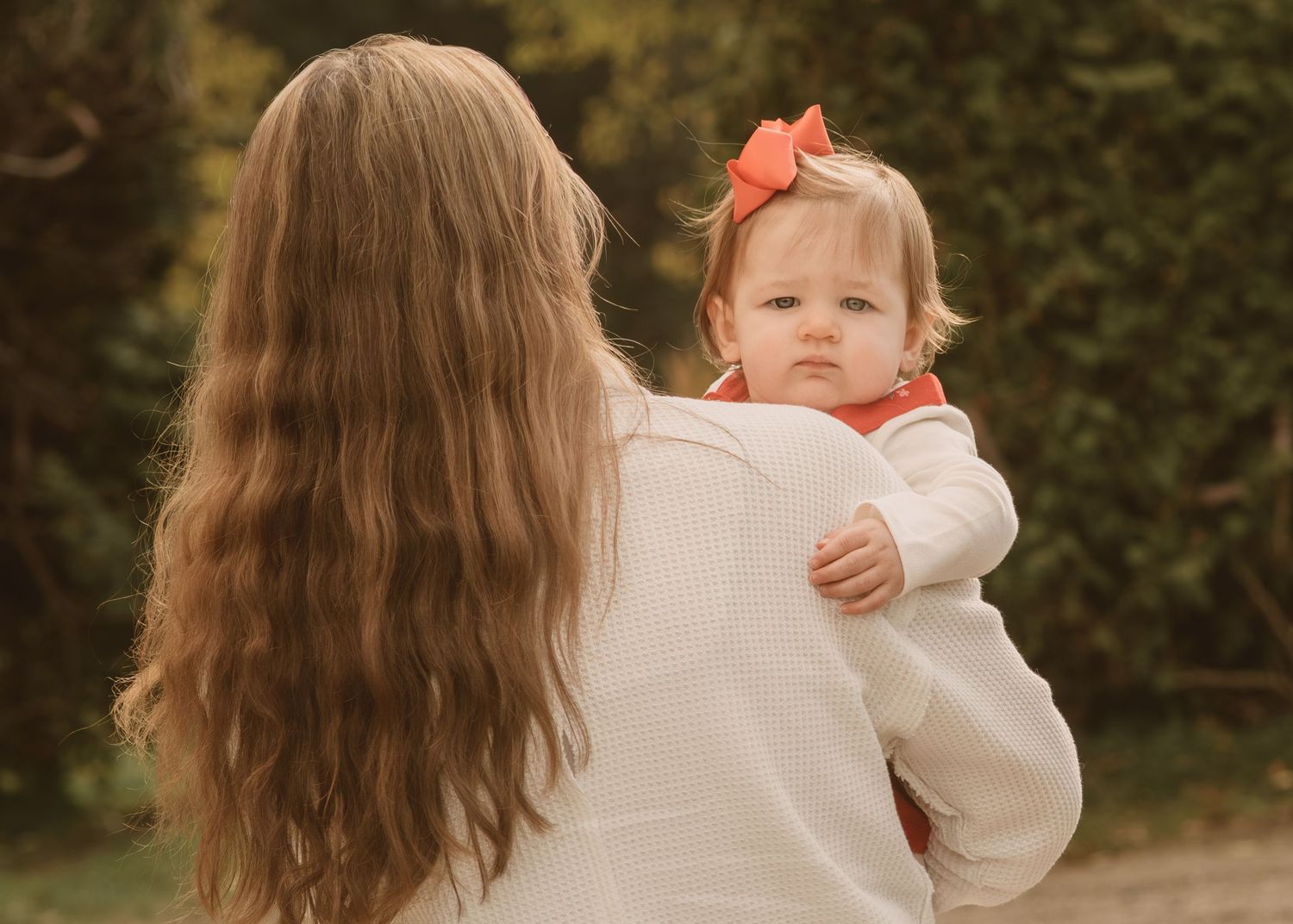 A gentle embrace captured from behind against a soft autumn background.
