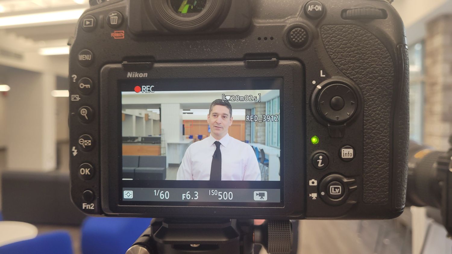 A photo of behind the scenes of a videography shoot.