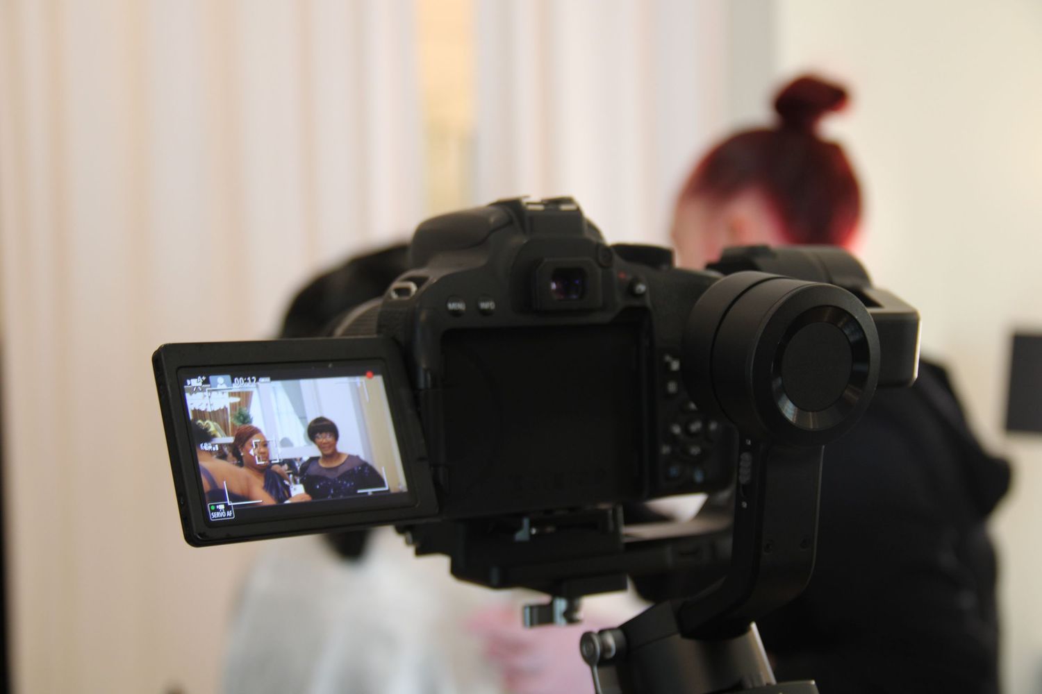 A photo of behind the scenes of a videography shoot.
