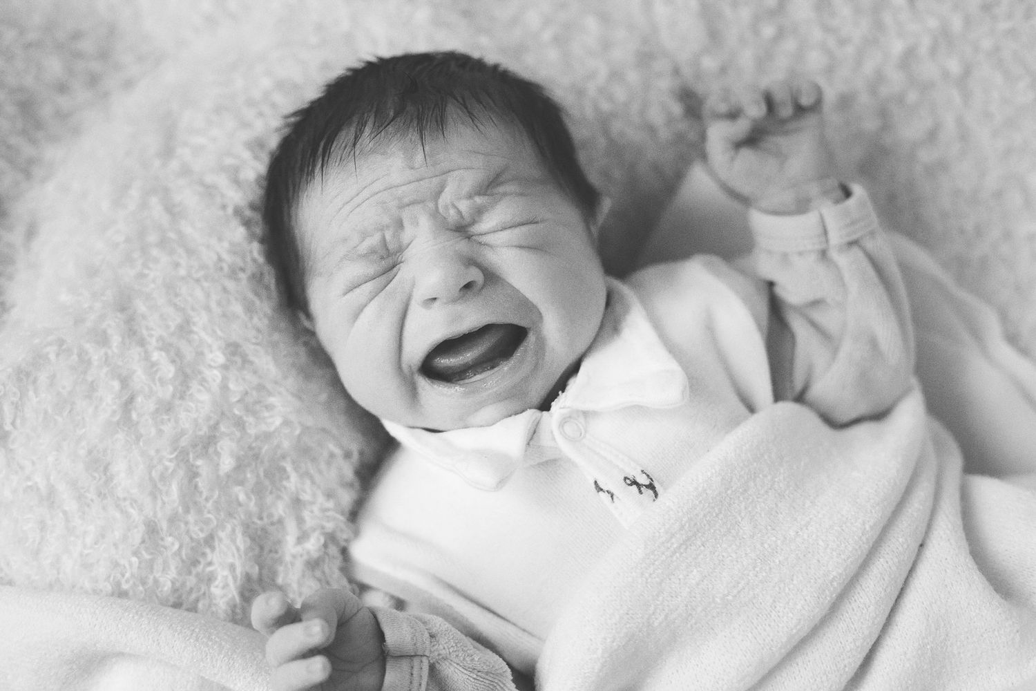 Collection of expressive newborn baby moments in black and white photography.