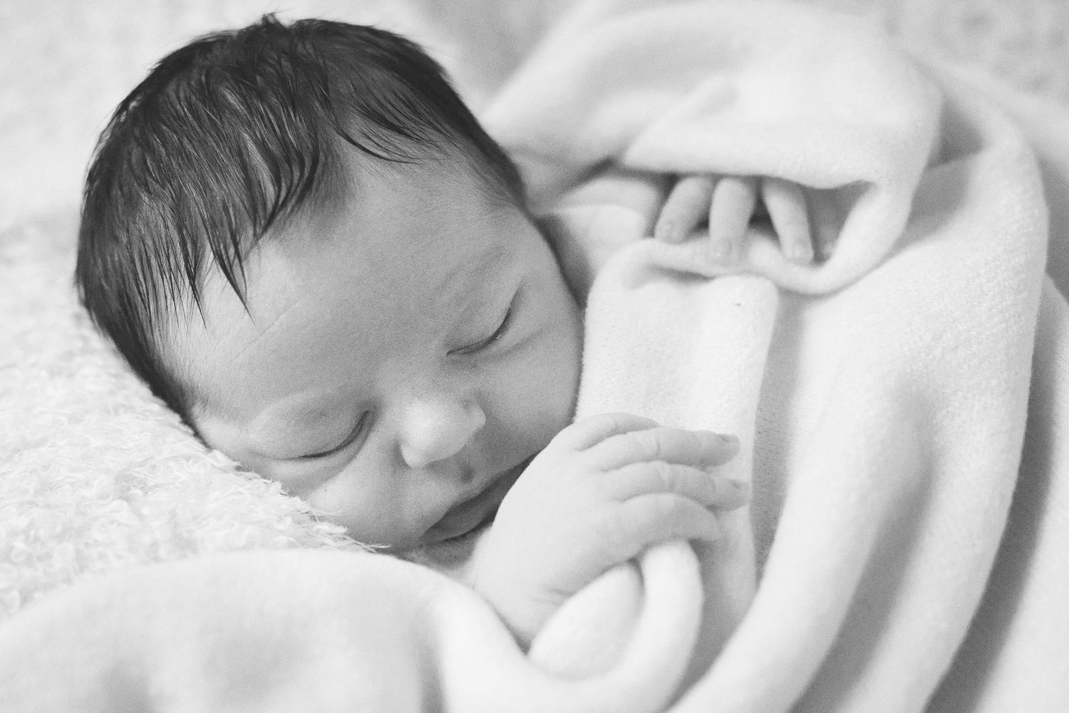 Artistic black and white series of newborn baby close-up shots.