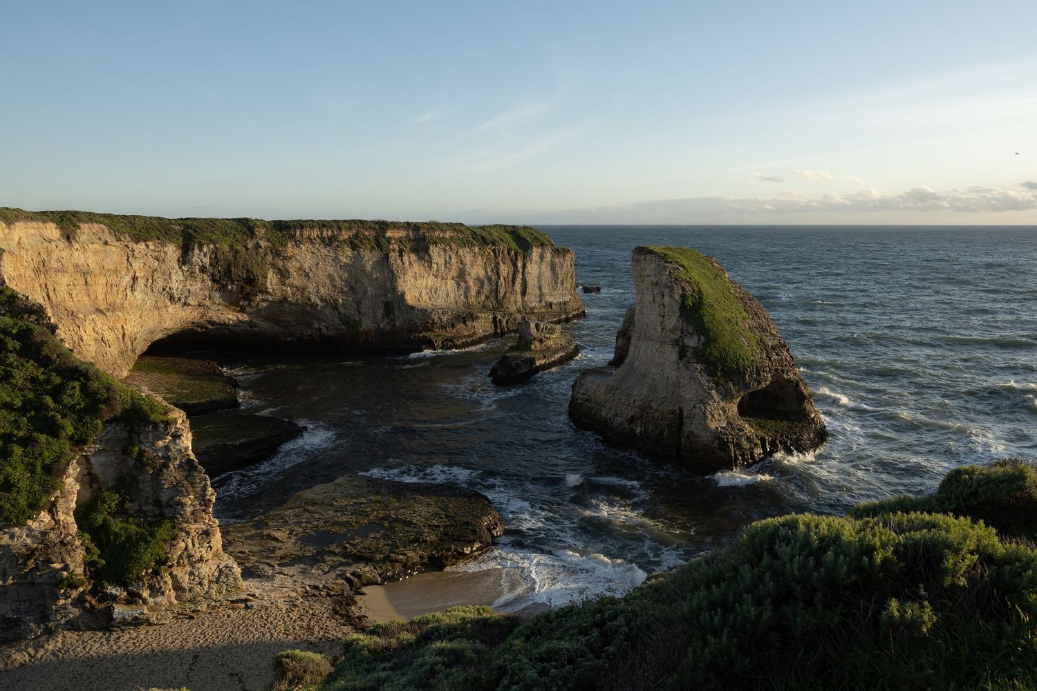 Dramatic coastal cliffs and rock formations at Shark Fin Cove along the Pacific coastline in Davenport, California.