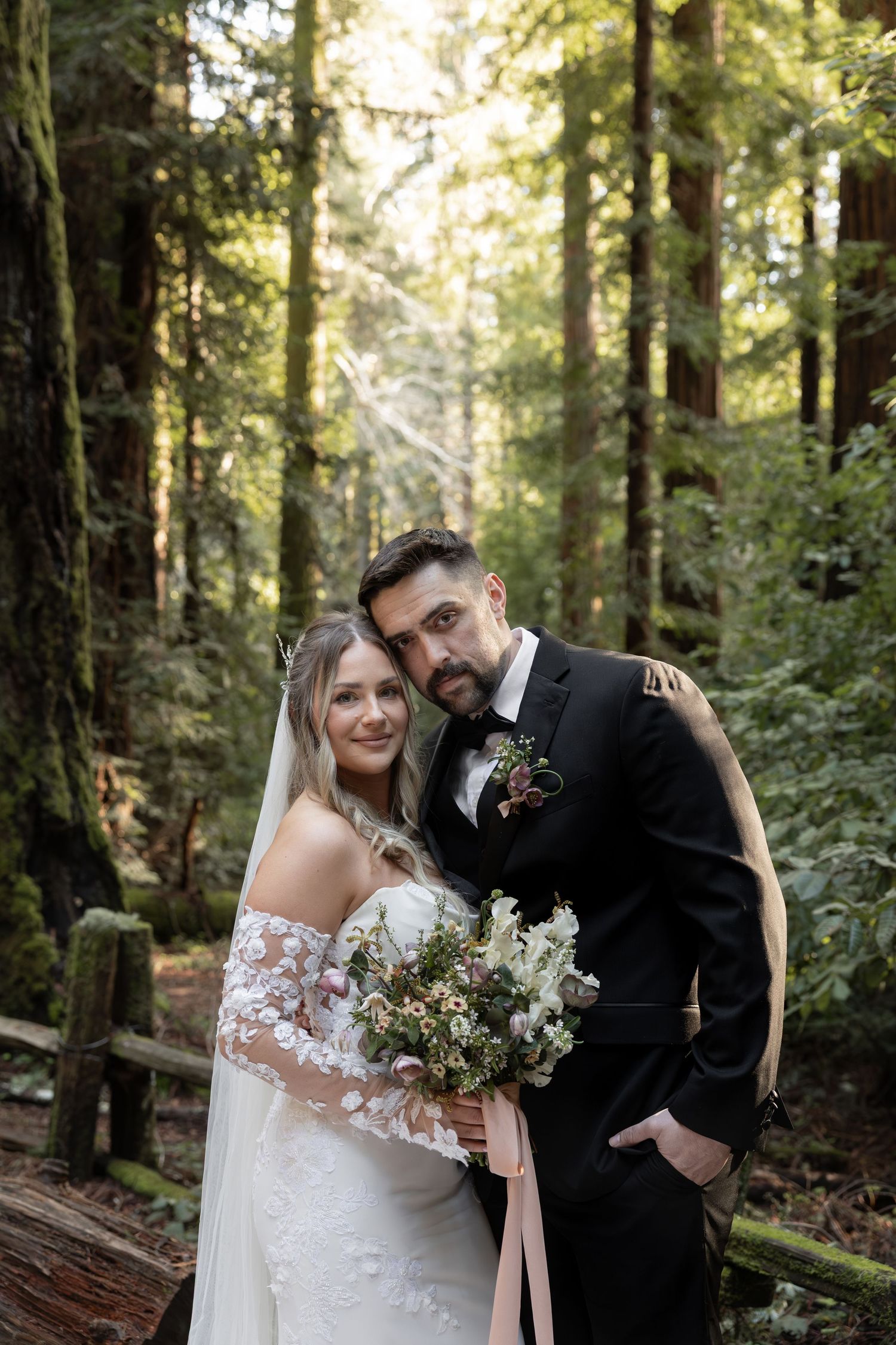 Bride and groom smiling in a redwood forest on their elopement day in California by Taylor Zimmerman Photo