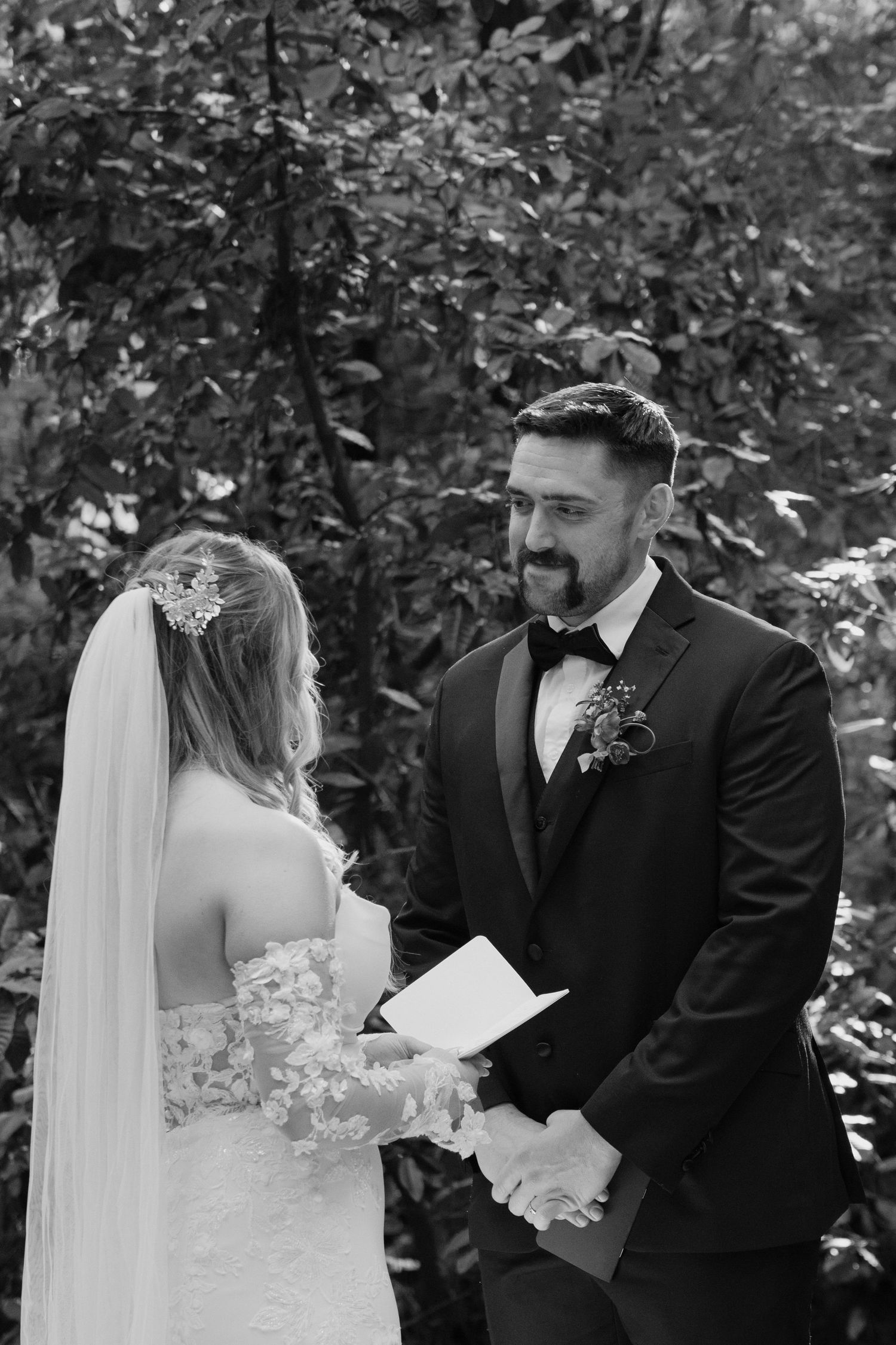 A groom smiling at his bride during redwoods vow exchange in black and white by Taylor Zimmerman Photo