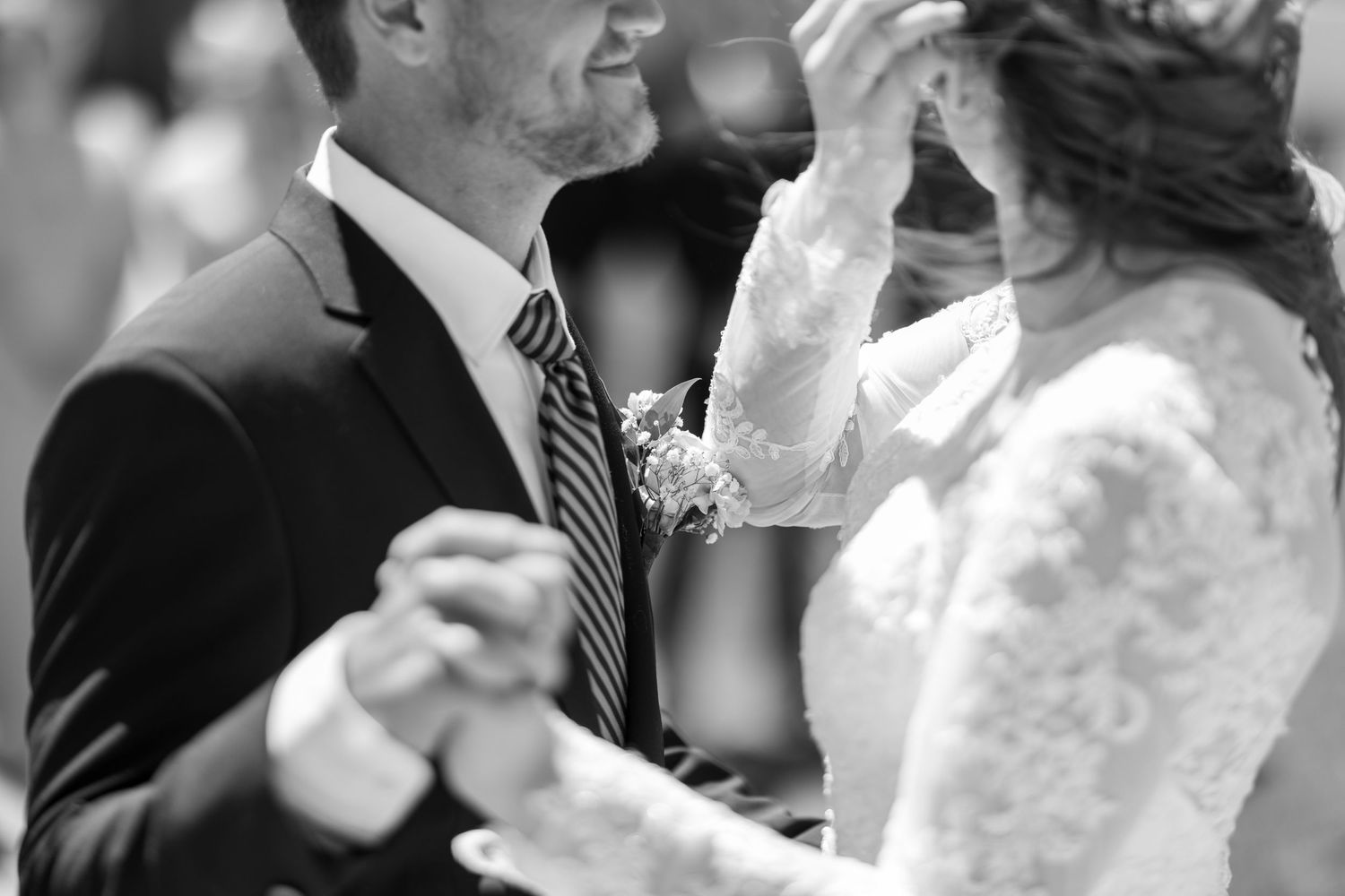 Bride and groom sharing their first dance in black and white wedding photography.